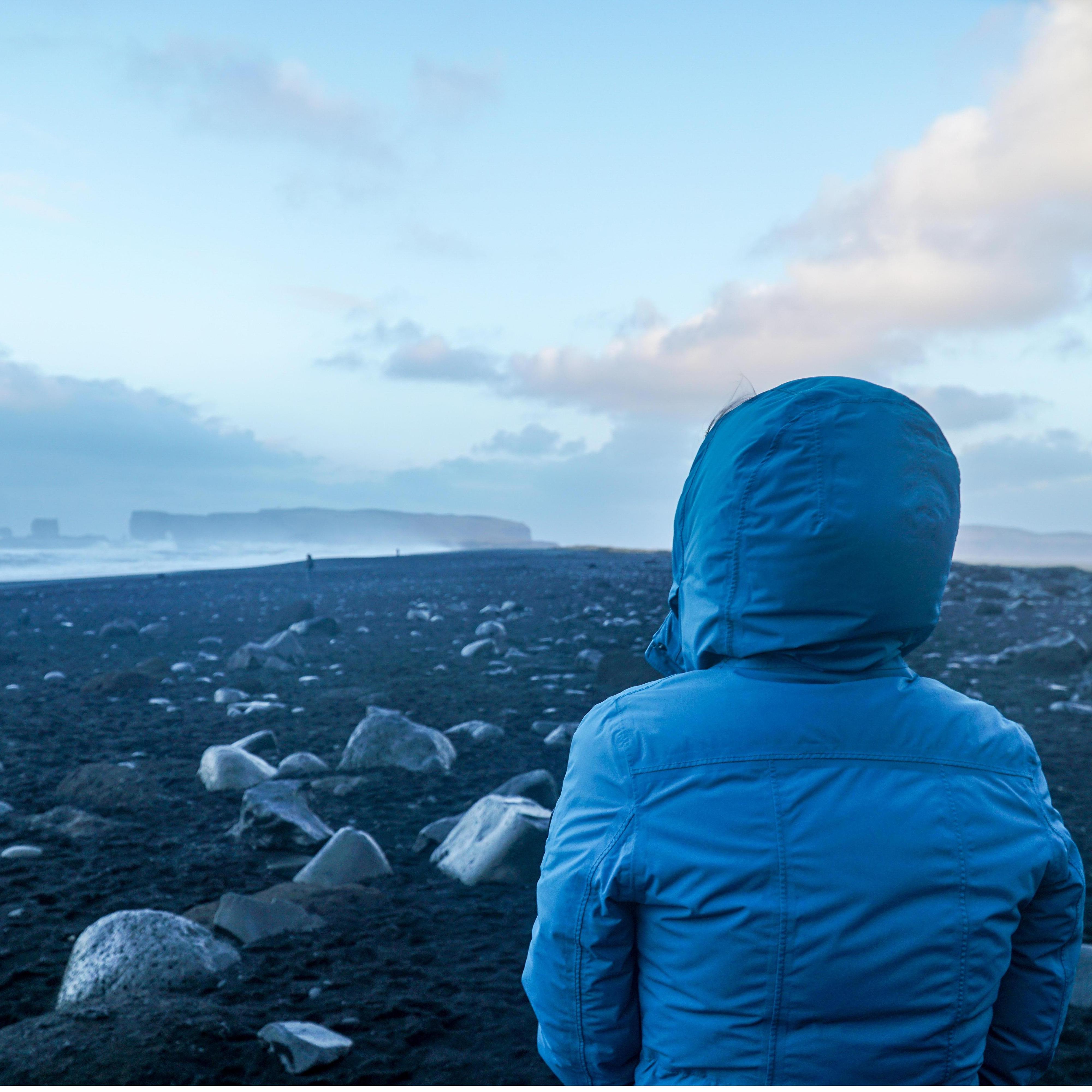 Black sands beach in Iceland. Parka on the beach a necessity!