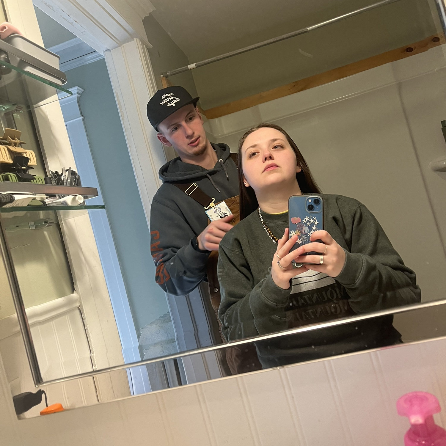 Seth is brushing Shauna's hair on an early morning, getting ready for a day of snowboarding.