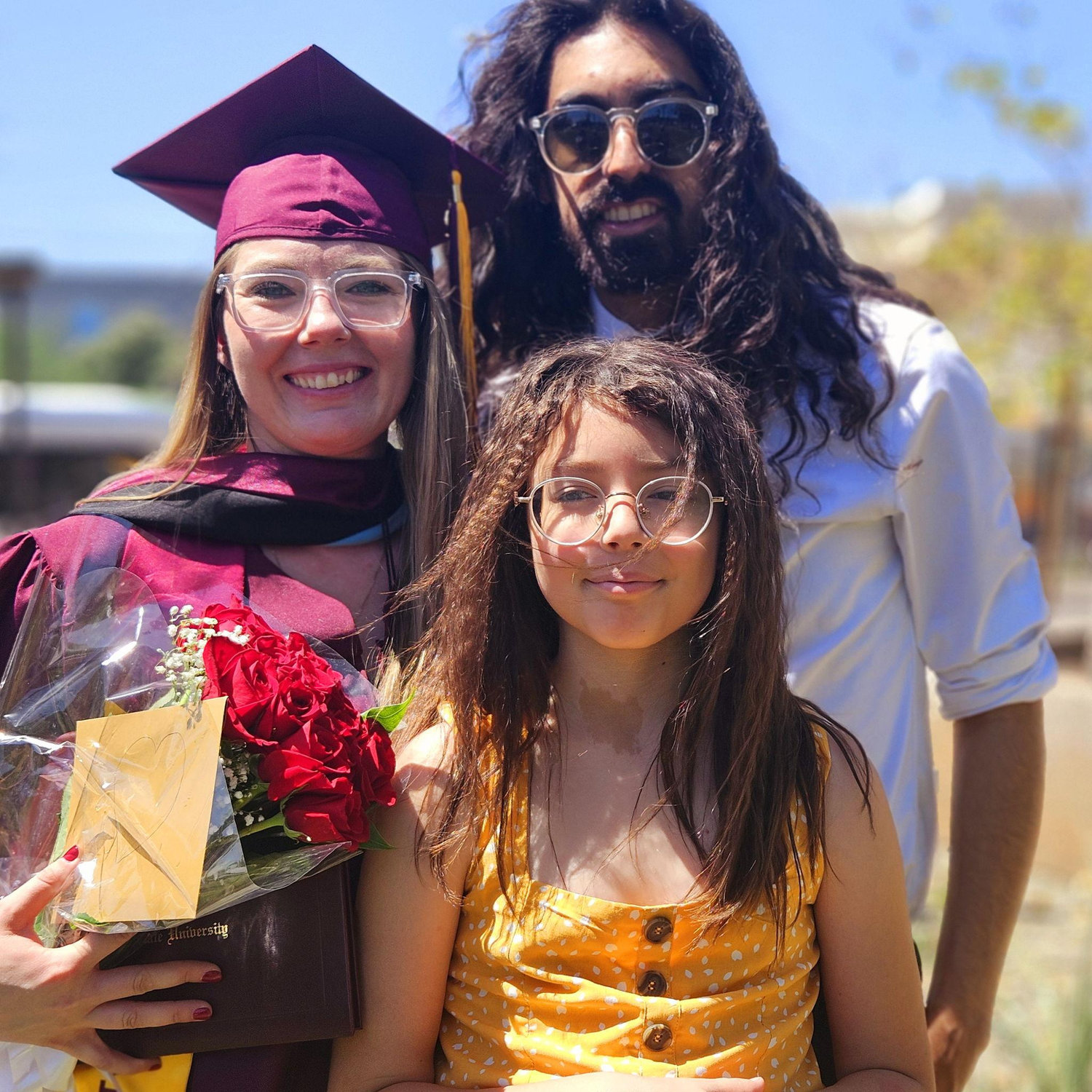 Family photo following Marina's Master's graduation in 2025.