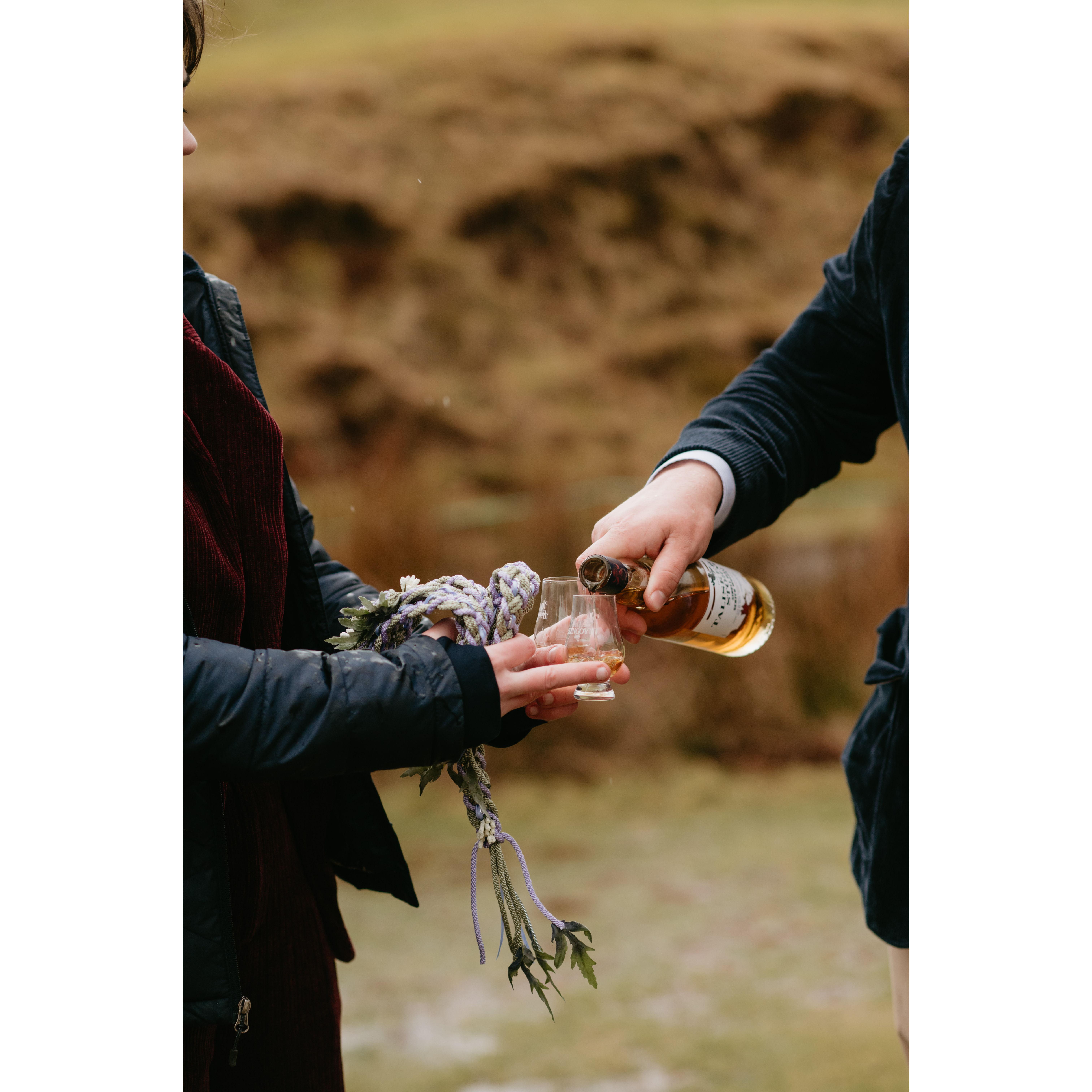 Group toast with a bottle of scotch Sally and Pat gifted Lauren and Chris from Talisker Distillery, which is located about 45 minutes away on the other side of the Isle of Skye!