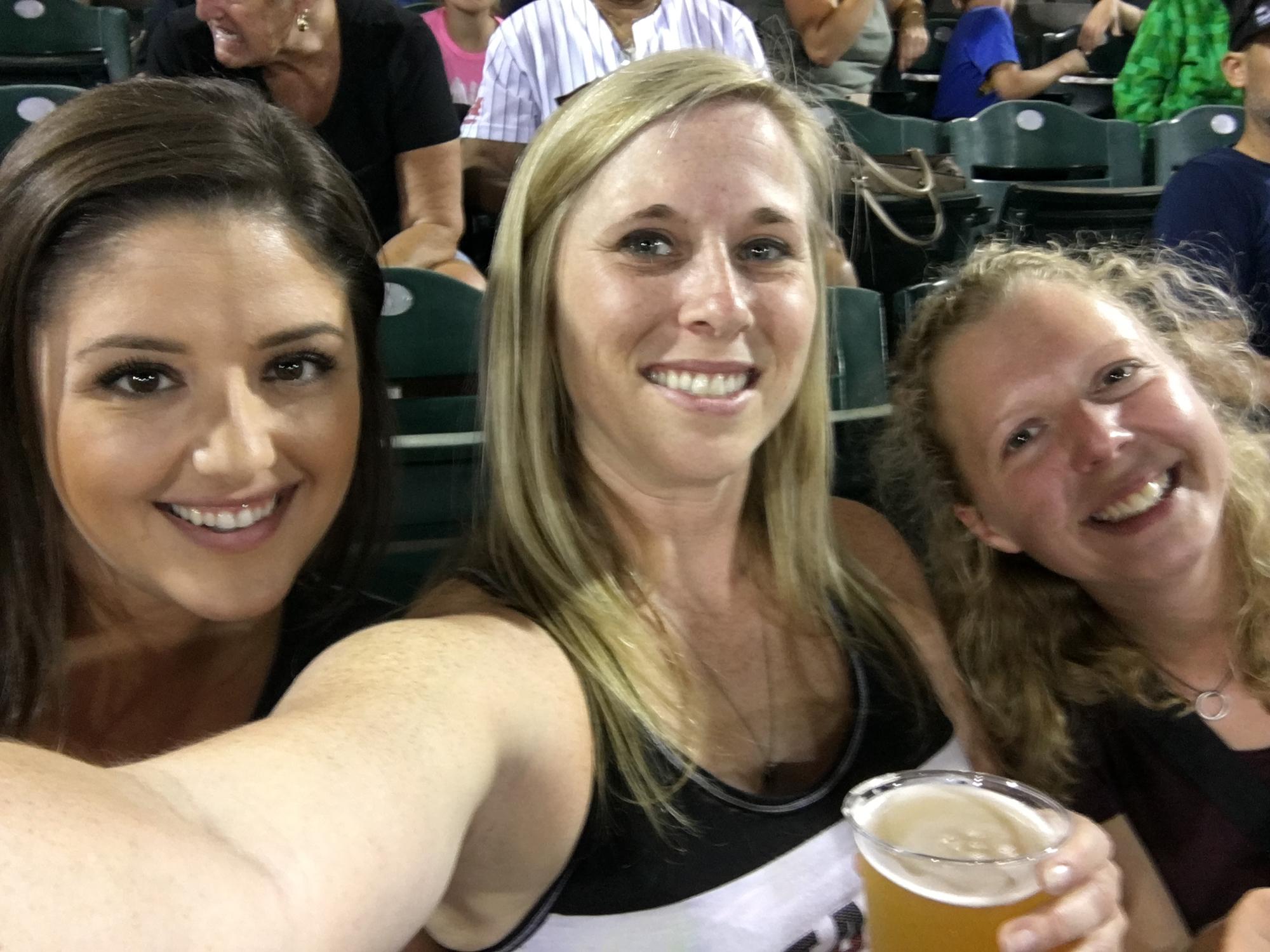 Caeli, Kimmy and Josephine having beers at a River Cats baseball game