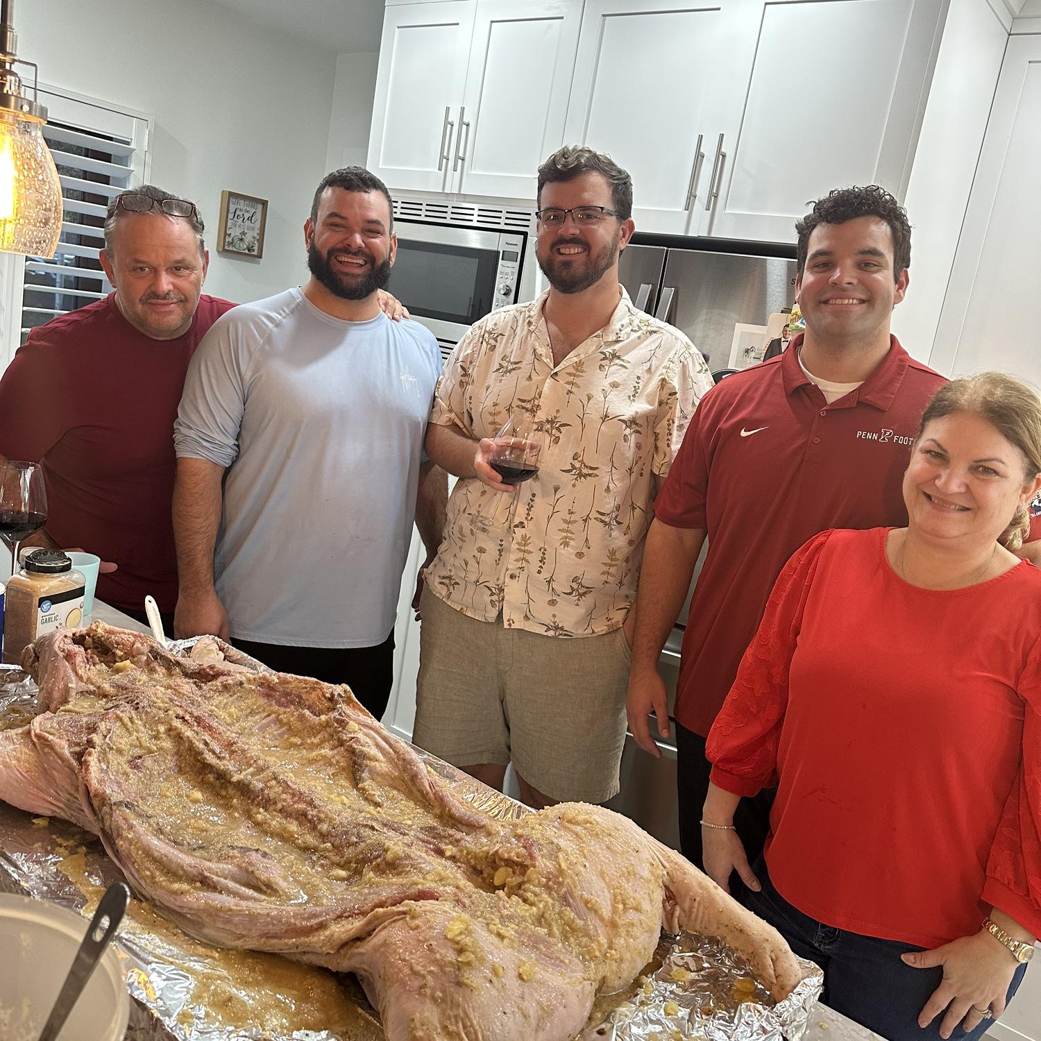 Showing John how to season the pig