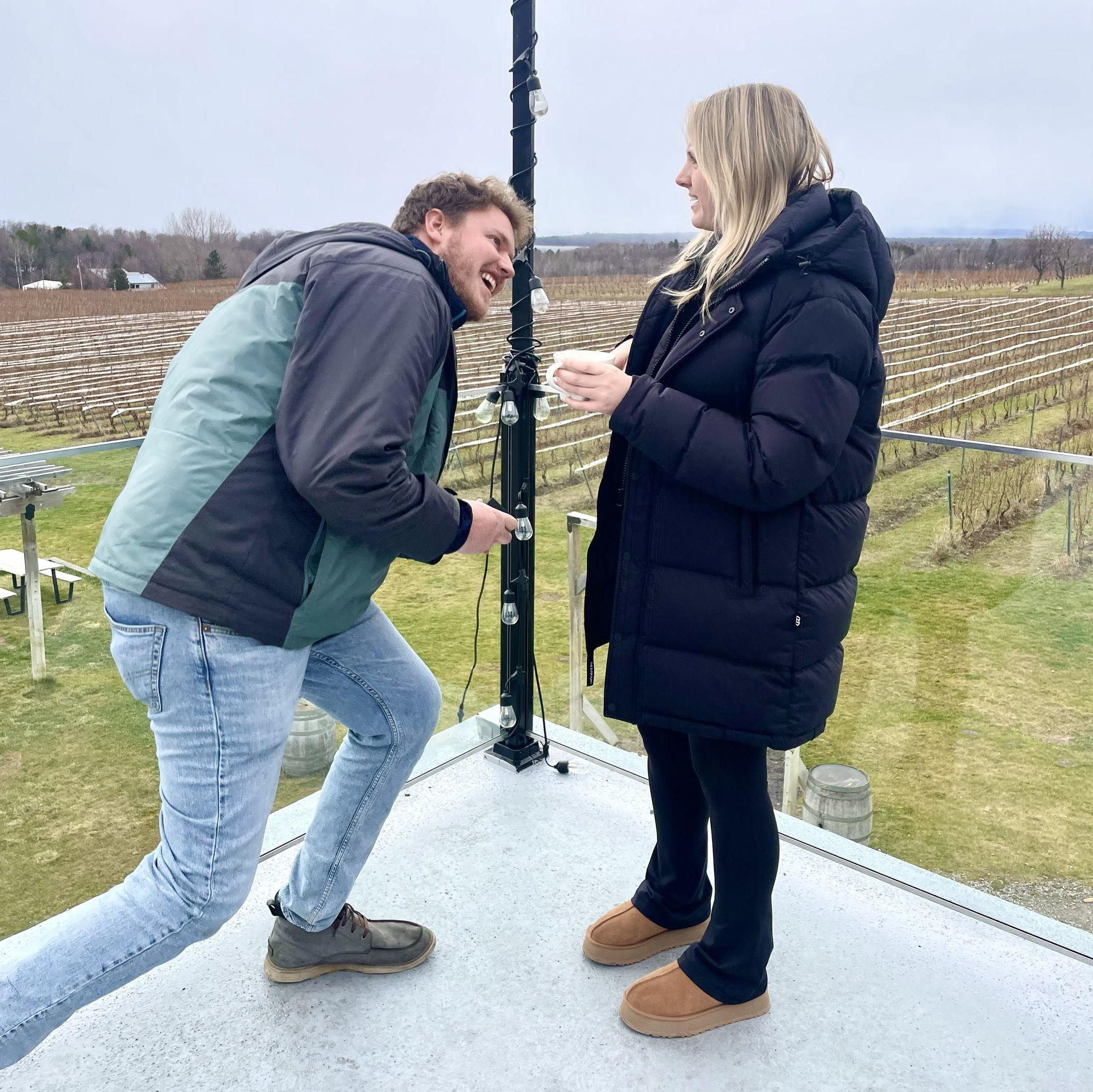 Will suggested to get a photo outside. Tiffani, suspecting nothing, was adamant about keeping their hot cocoa mugs in the photo, adding stress to Will’s plan to get the ring out.