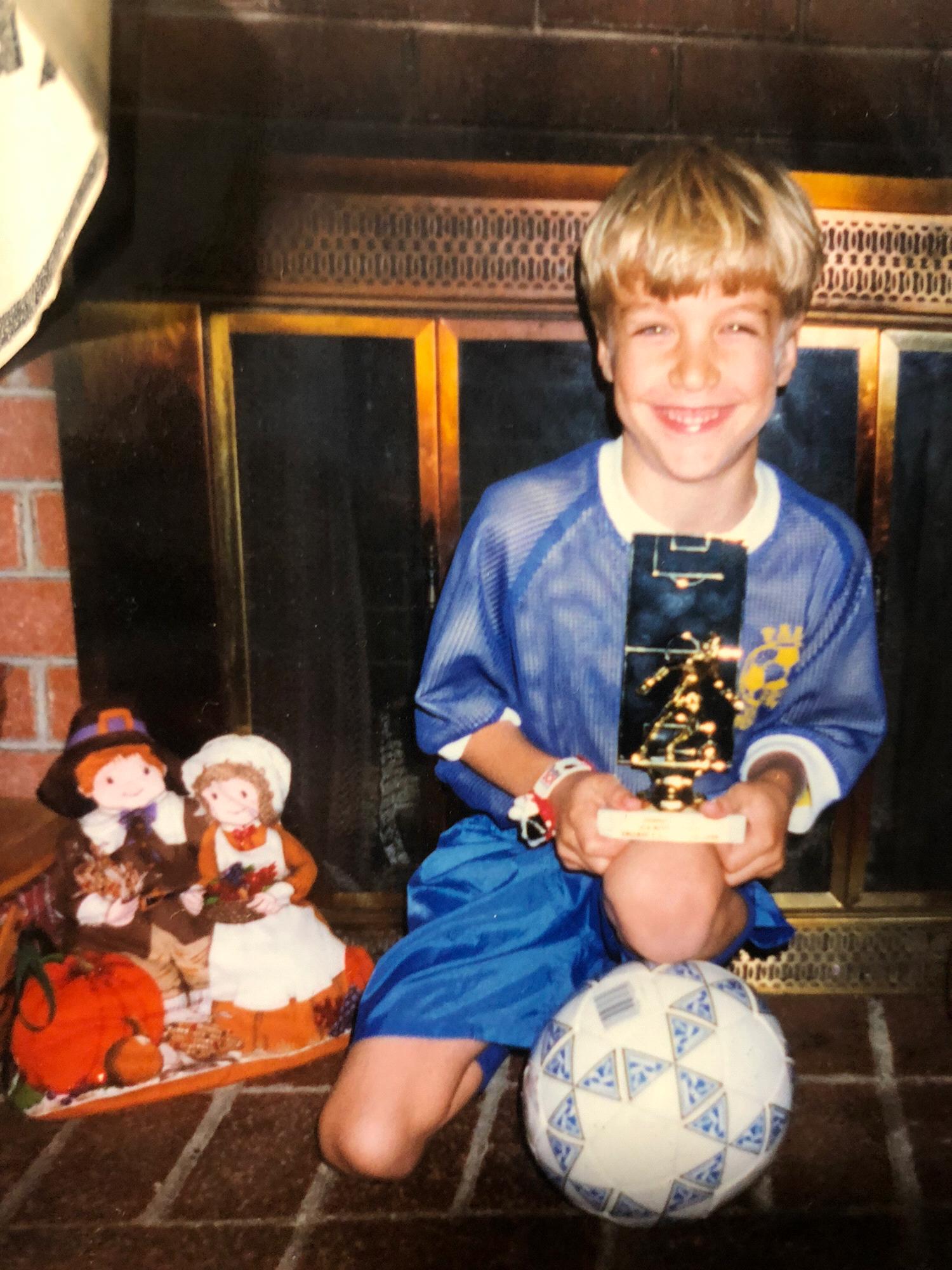 Conner and his soccer trophy
