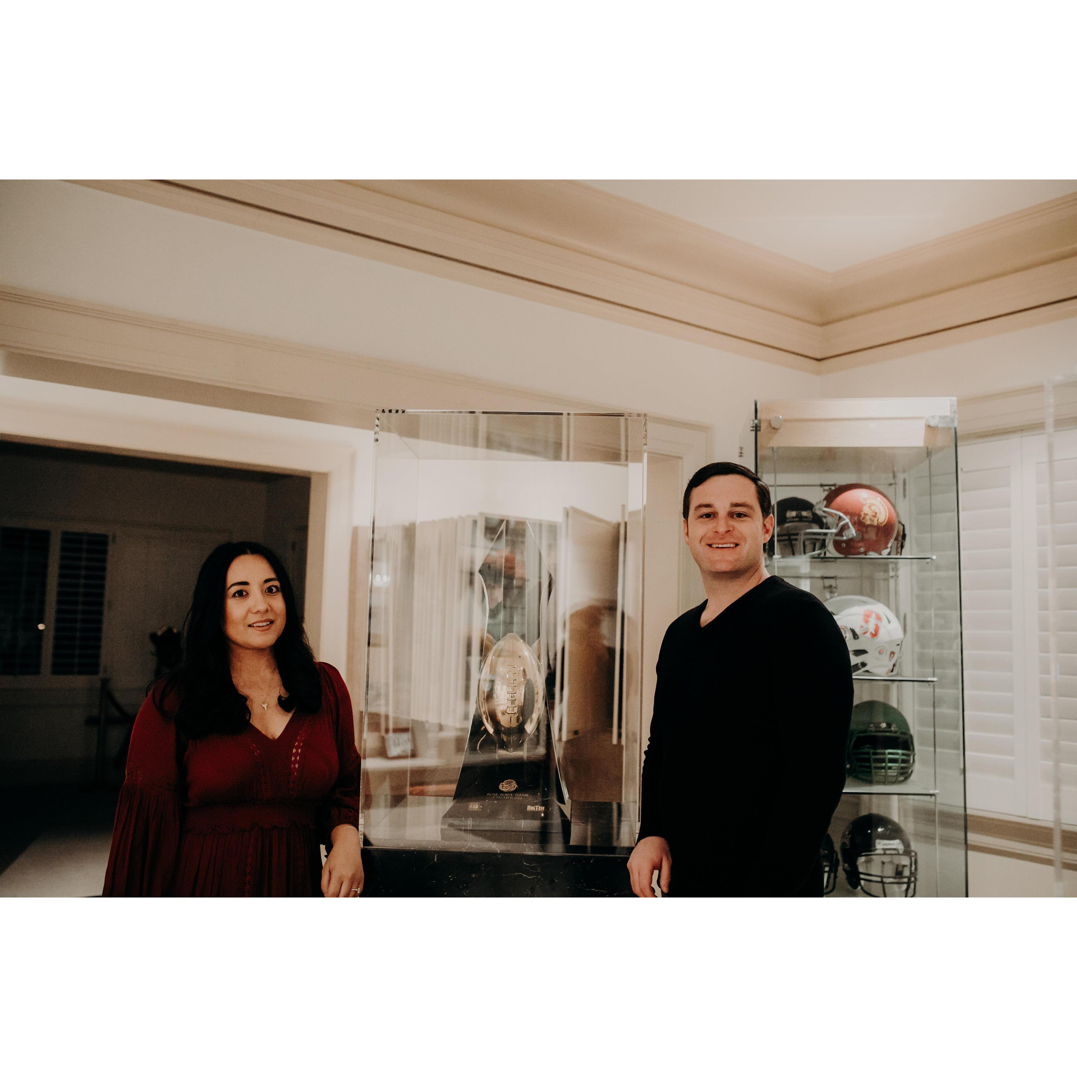 Kamala & Eric posing with the 2017 Rose Bowl trophy won by USC on display at the former Wrigley Mansion.