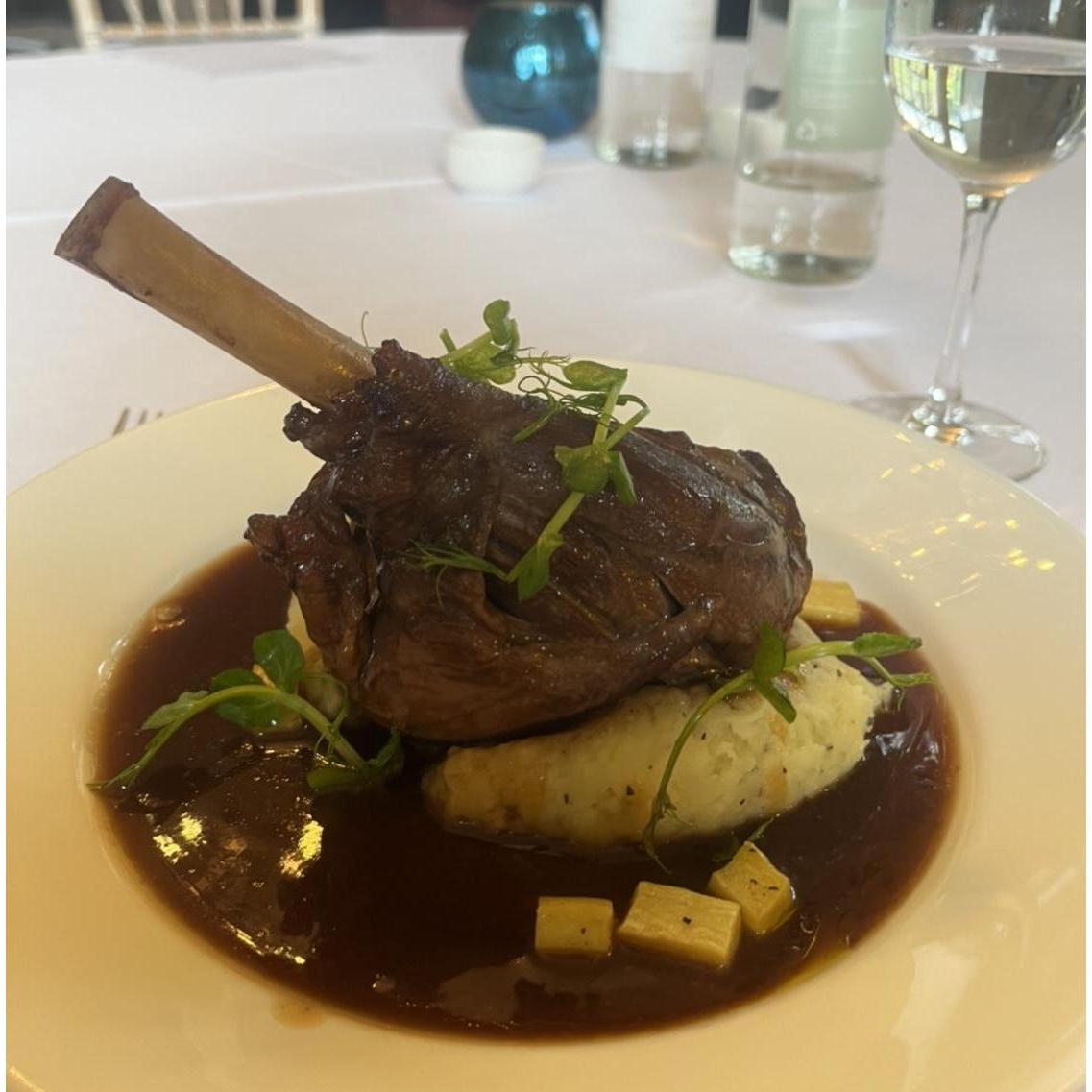 Main: Braised lamb shank with rosemary mash, confit parsnips and port reduction. Served with spring vegetables.