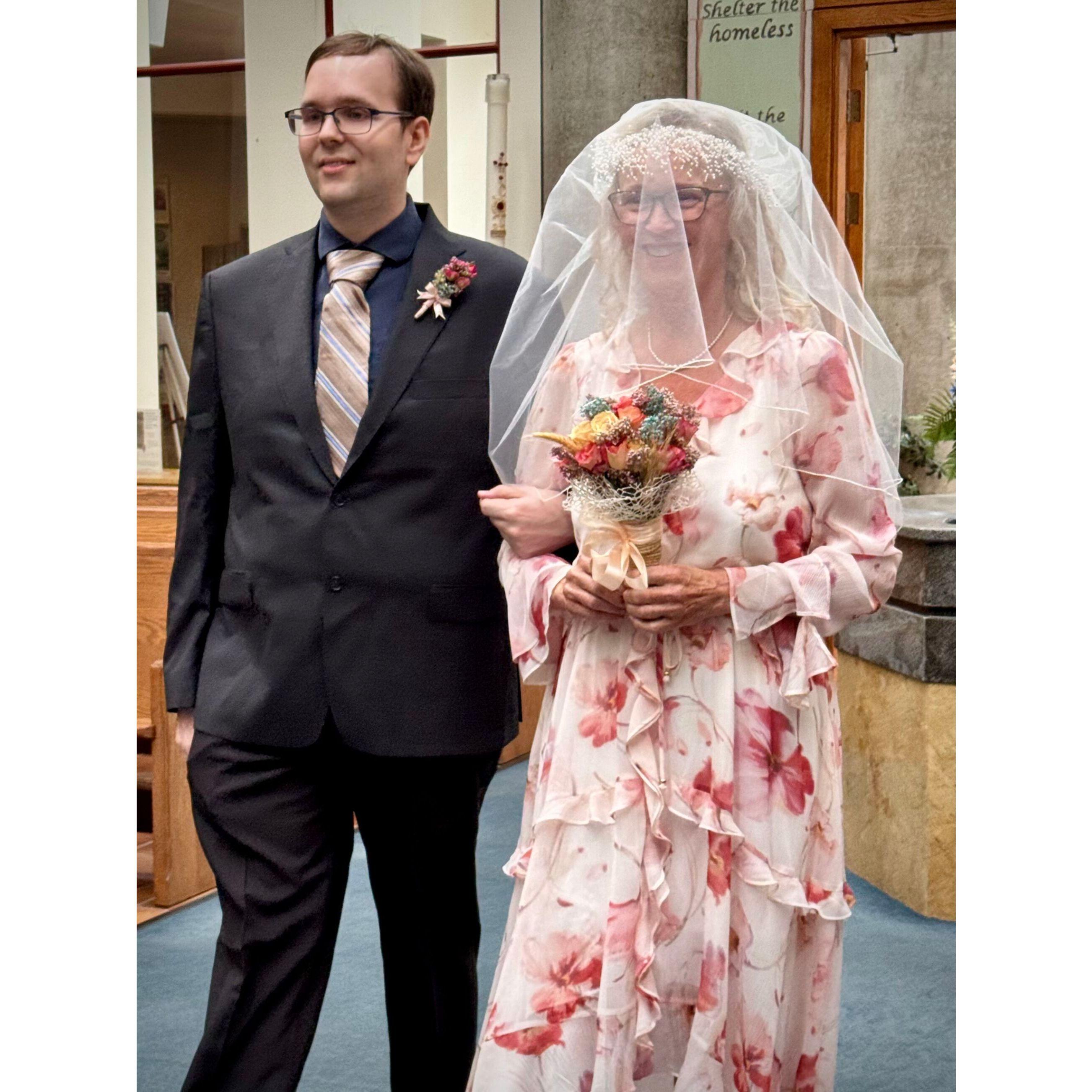 Anita is led down the aisle by her son Ryan.
