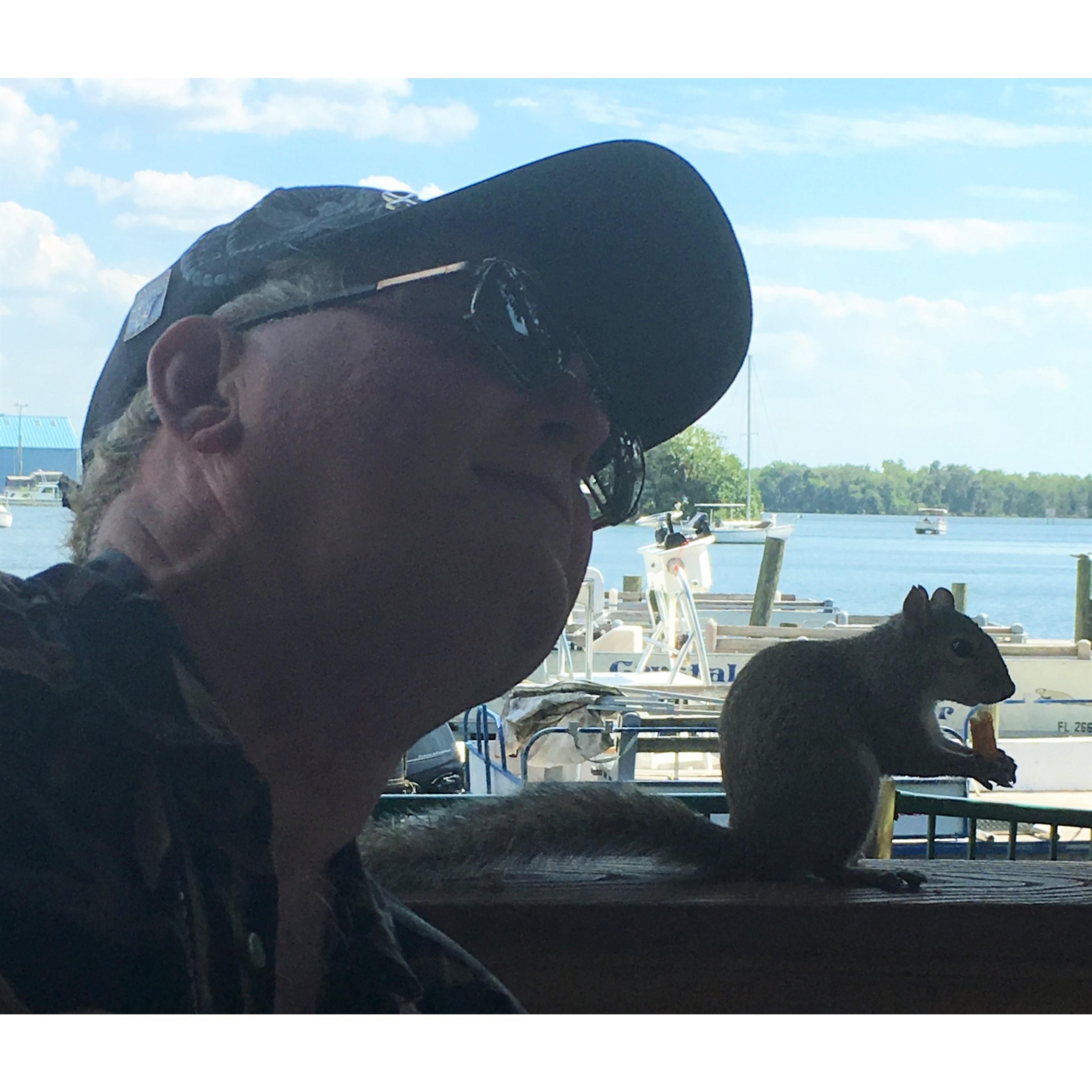 Always talking to the critters. He gave this squirrel some French Fries while we were dining outdoors at Crackers in Crystal River, FL. April 2016