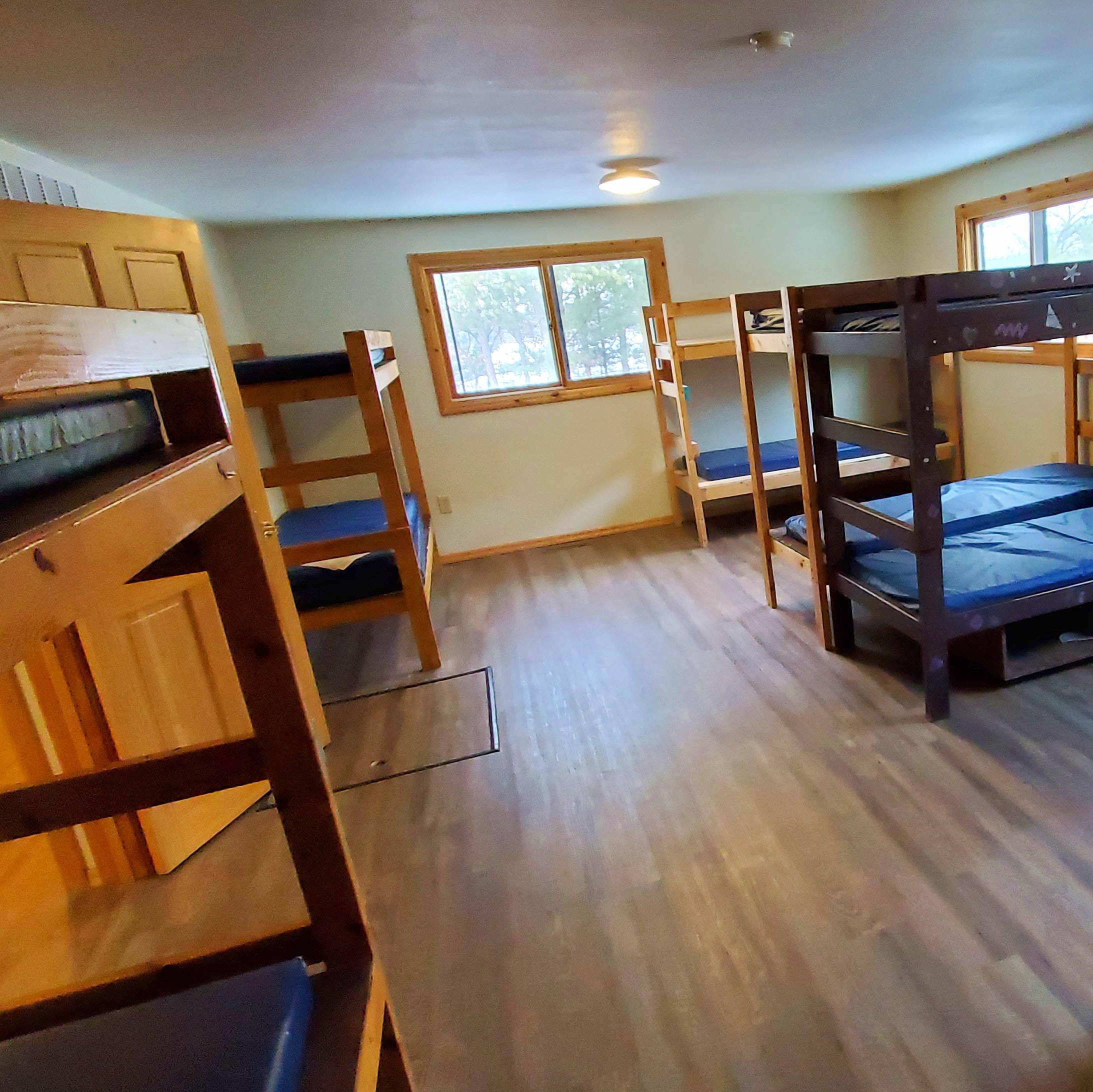 Bunk style cabins-There are 7 sets of bunk beds, a pull out couch, and room for a few air mattresses in each cabin. 2 bathrooms with showers in each cabin.