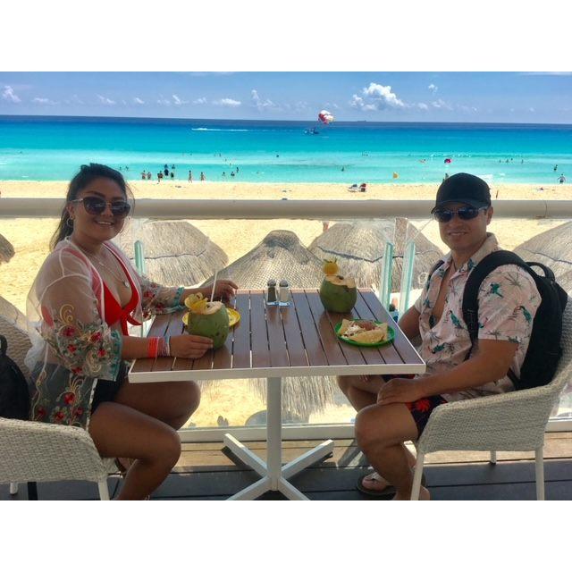Enjoying the cool breeze and fresh coconut juice in Cancun!