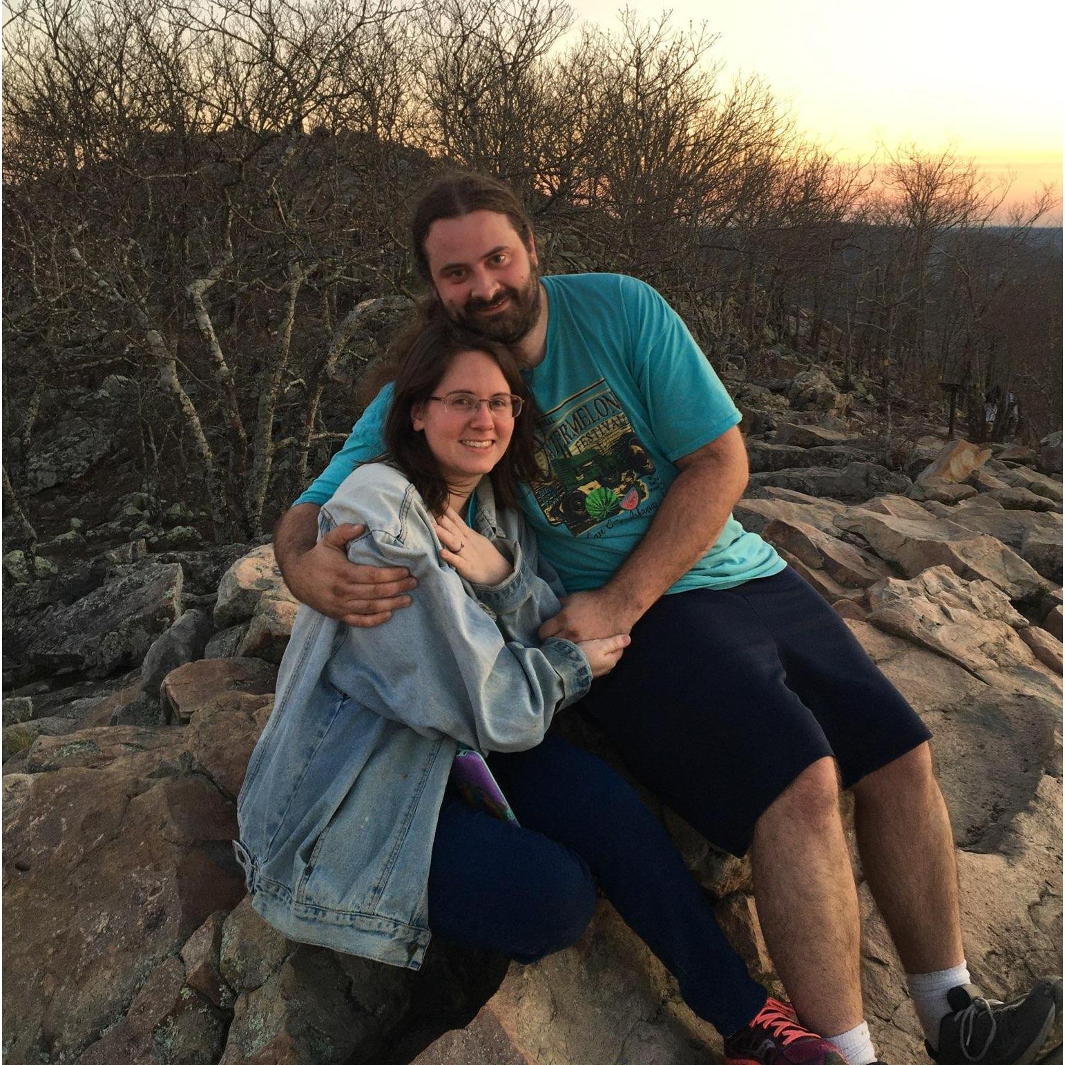 We got engaged on top of Pinnacle Mountain, in Arkansas. A fellow climber was kind enough to snap this photo for us, and she even got the proposal on video!