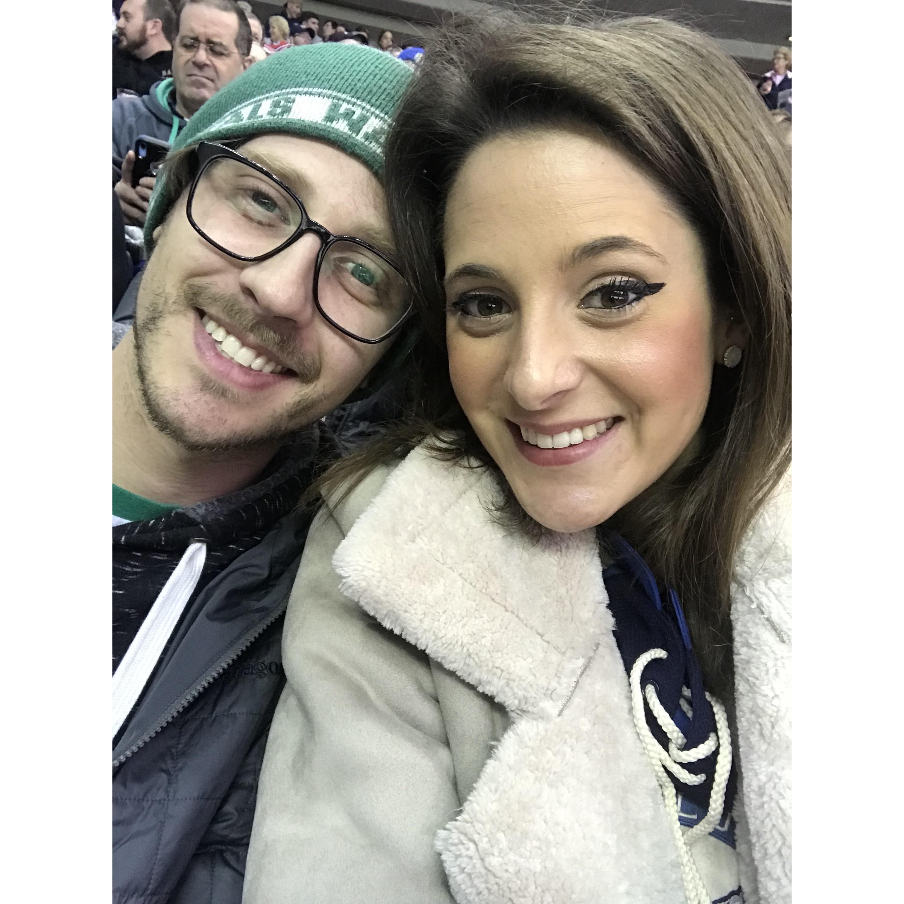 We like to go to hockey games. We also like taking pictures of men staring intently at their cell phones. Two-in-One!