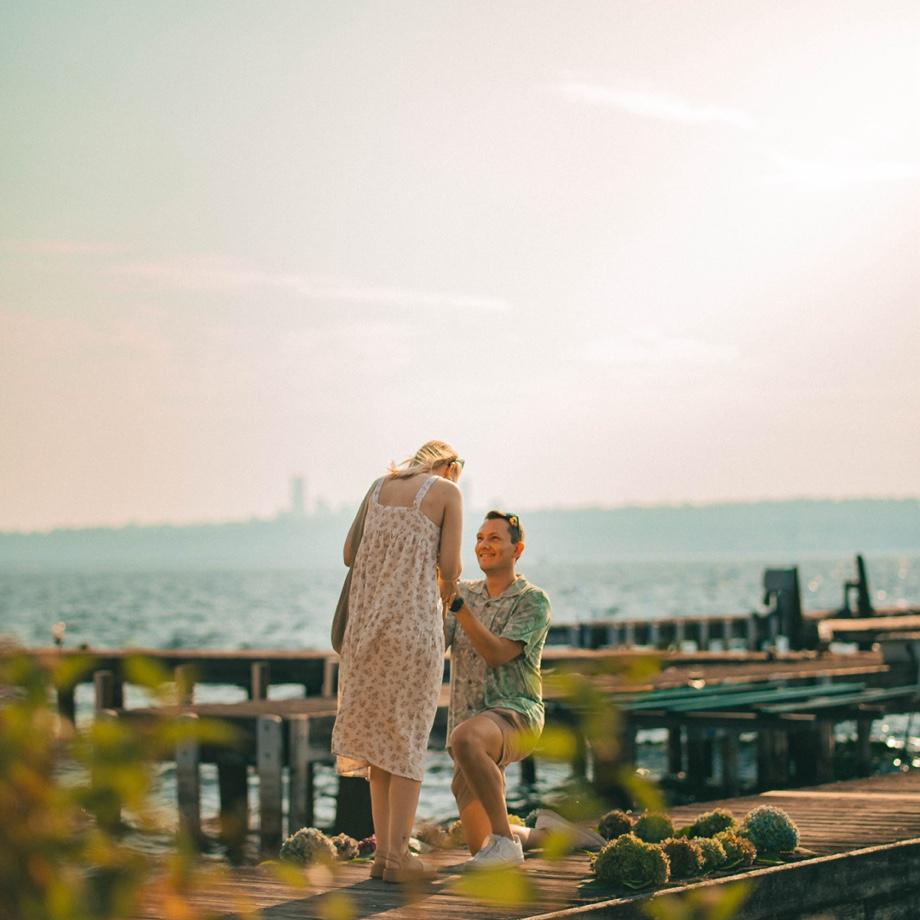 The big moment!! Shoutout to the Leavens, Tim, Mick, and Peter G for surprising Lauren when she turned around! And for placing the flowers out on the dock despite a very windy day.