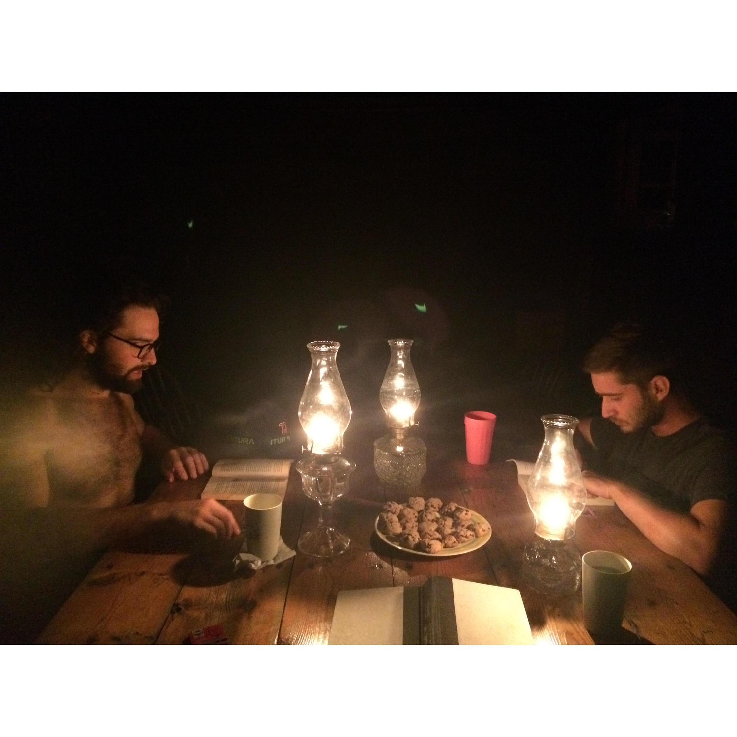Nelson and Mike enjoying cookies by candle light on Rainbow island
