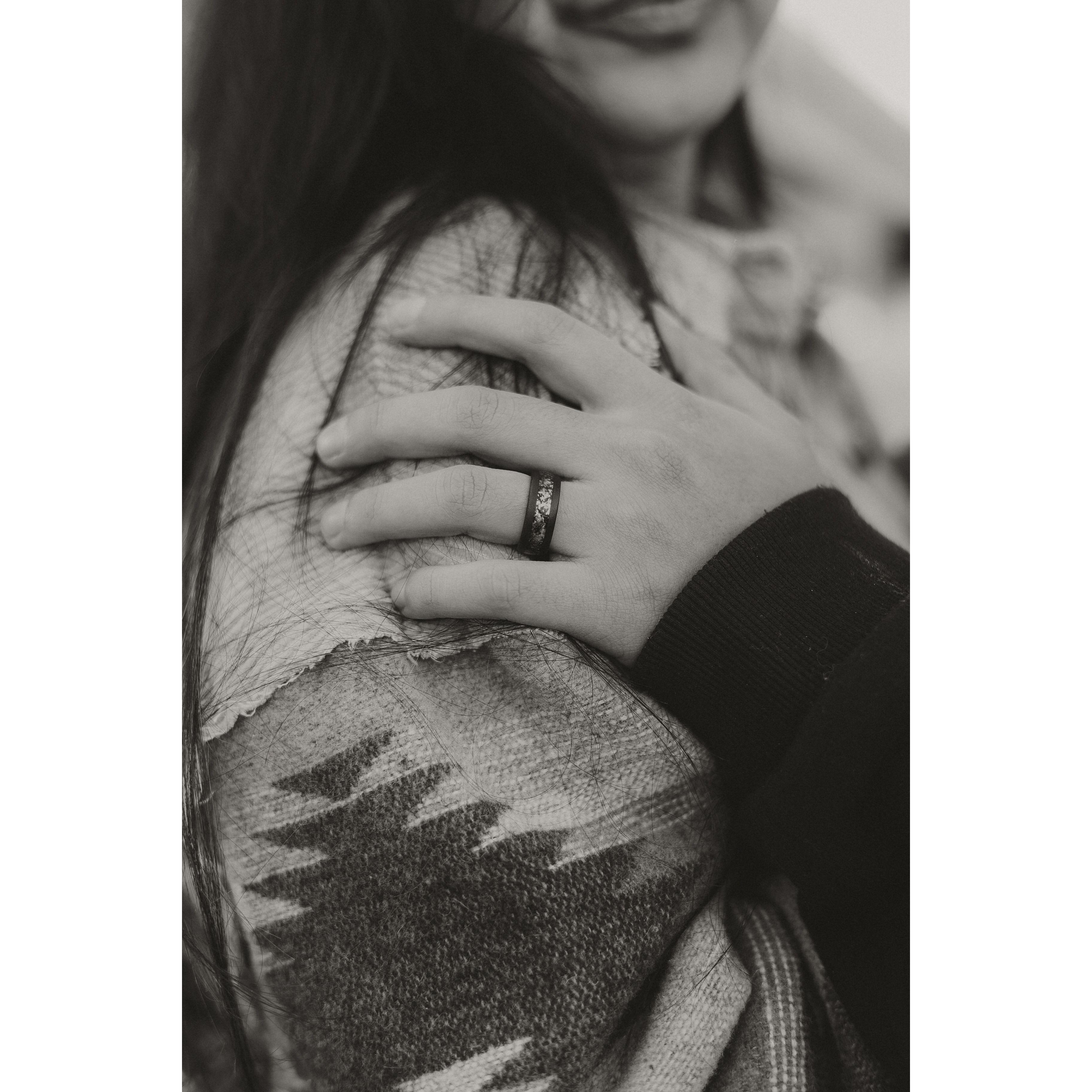 His ring is made with tungsten and opal :D