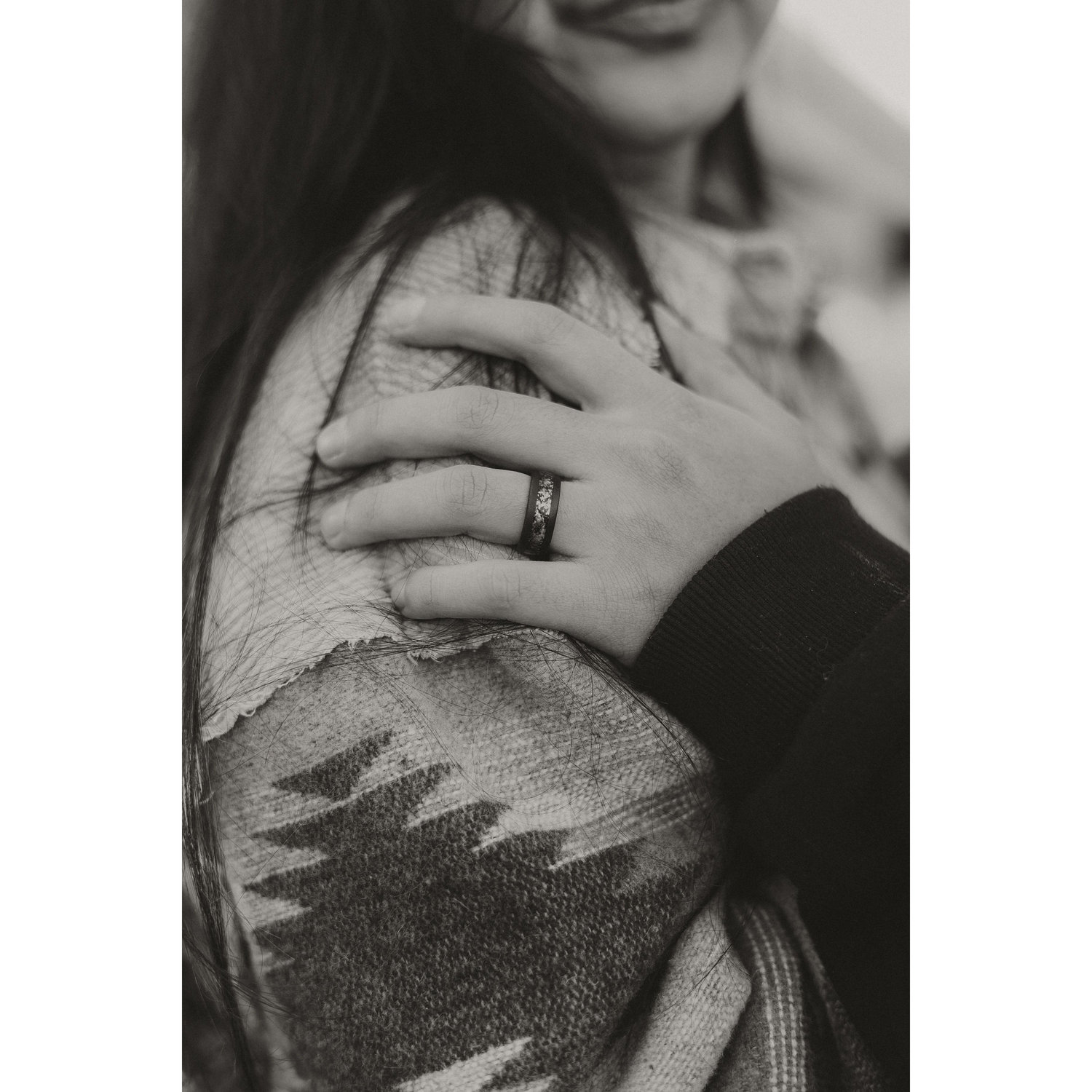 His ring is made with tungsten and opal :D