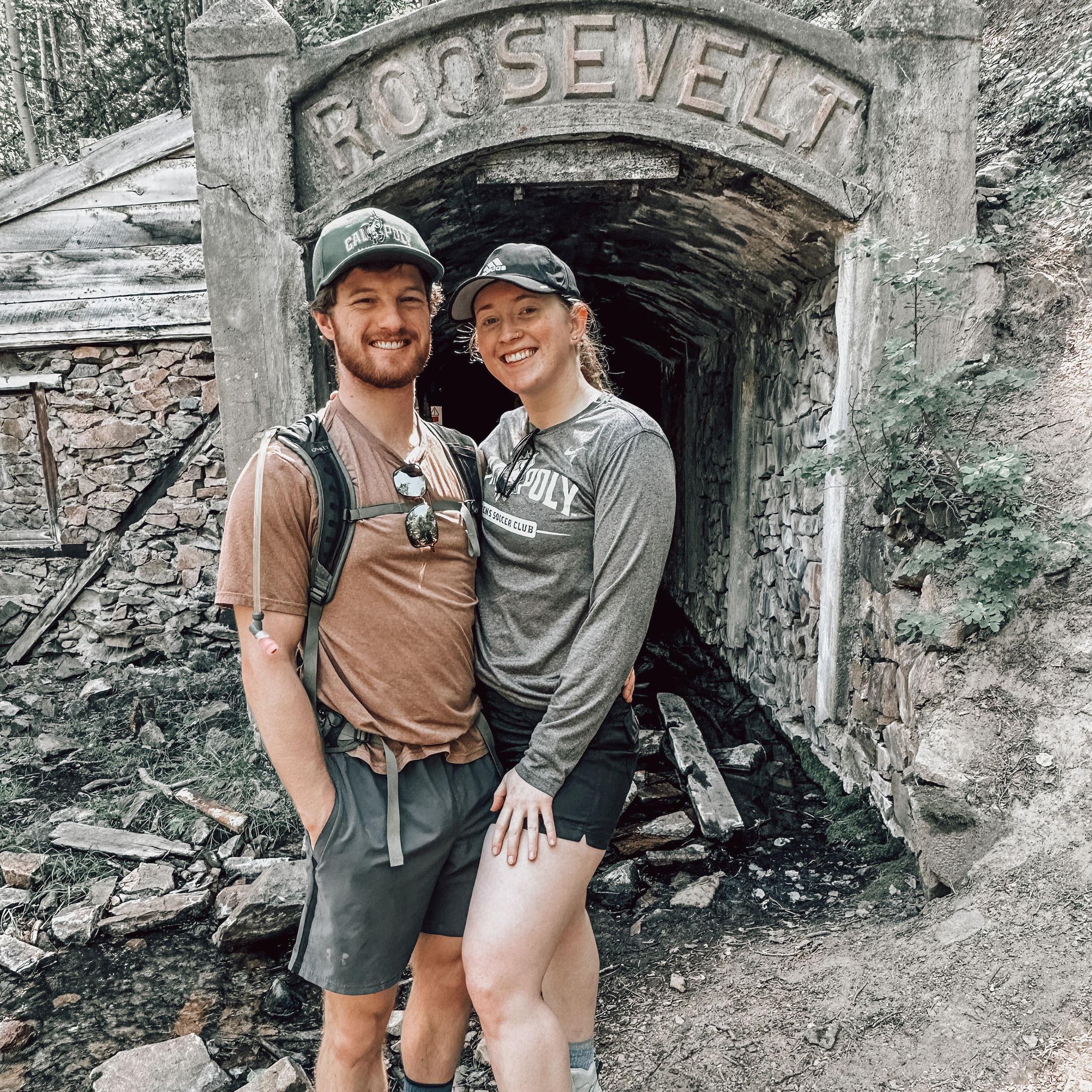 Hiking near Pitkin, CO in September 2023 with Gab's parents, brother Shane, and sister-in-law Tori (the day they got engaged!). Meanwhile, Gab got stung by a bee in the cave behind us in the photo!