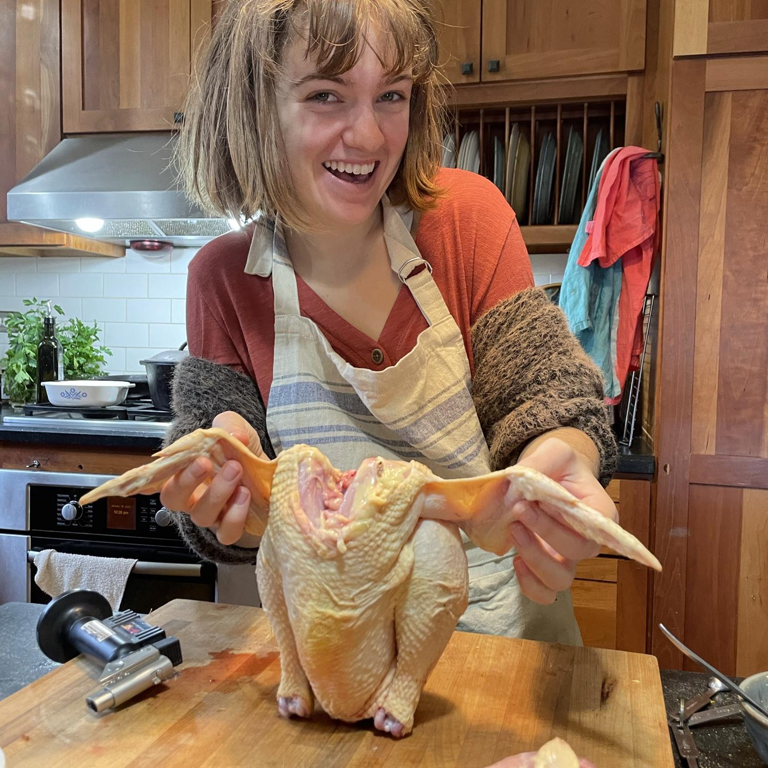 Lucy preparing the first chicken she slaughtered and processed.