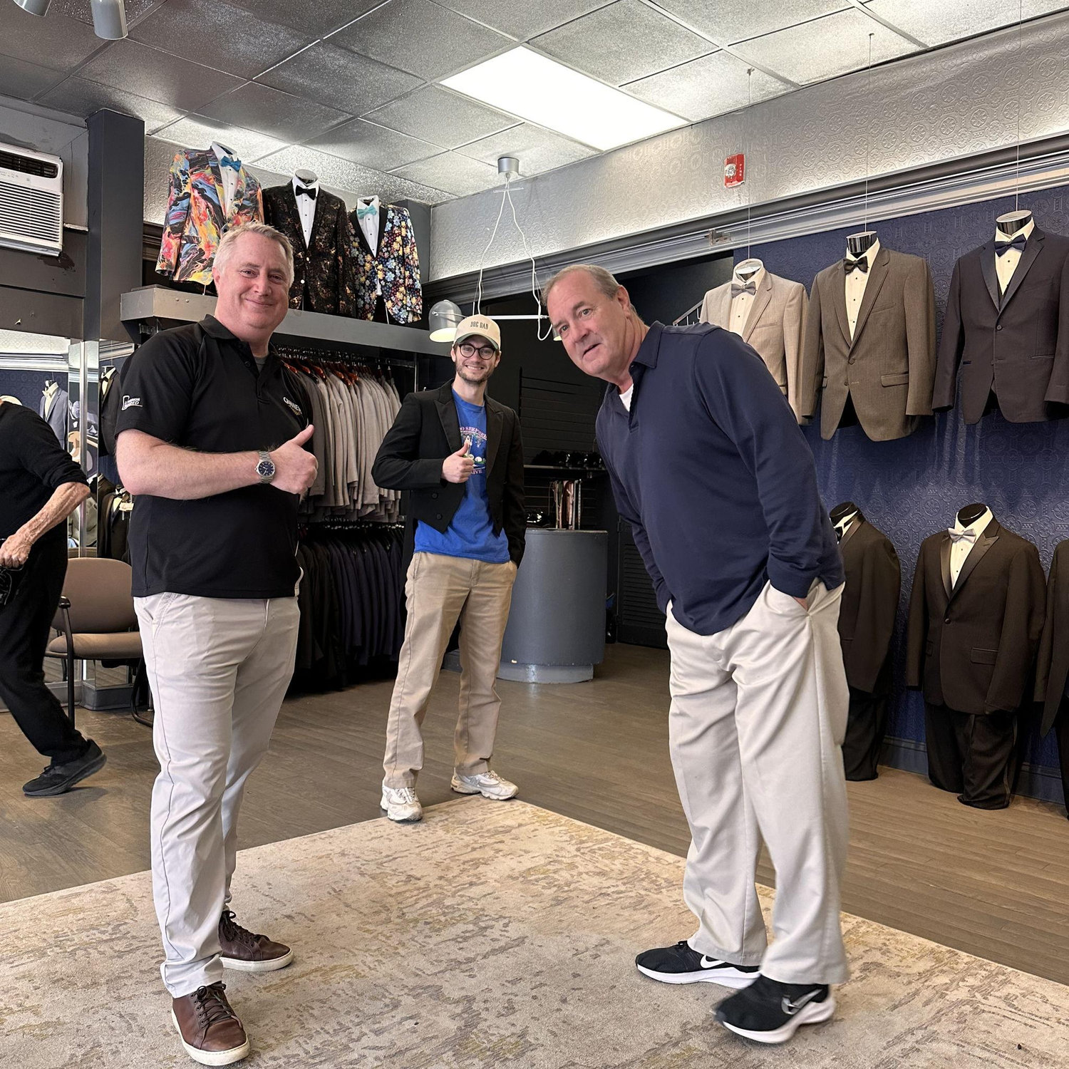 The "guys" trying on tuxes!