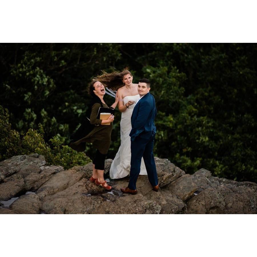 When we realized the rings were with our photographer 200 yards away on another cliff. Note: the wind was so strong that my hair stayed like this most of the time.