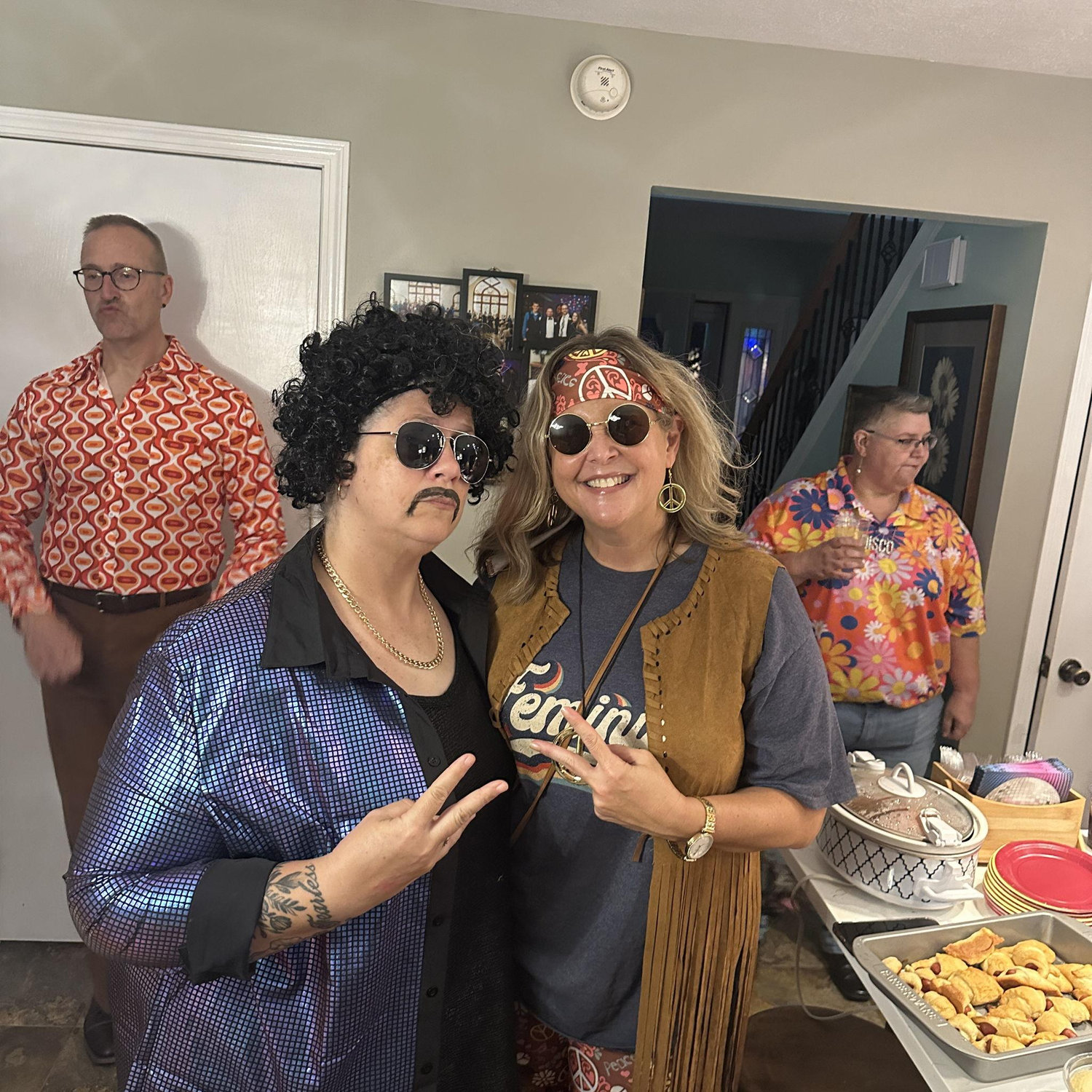 Kristy is the happy-go-lucky-hippie on the right. And Lisa is the 70's mustachioed, disco man, that ended up looking like a Ron Jeremy look-a-like.