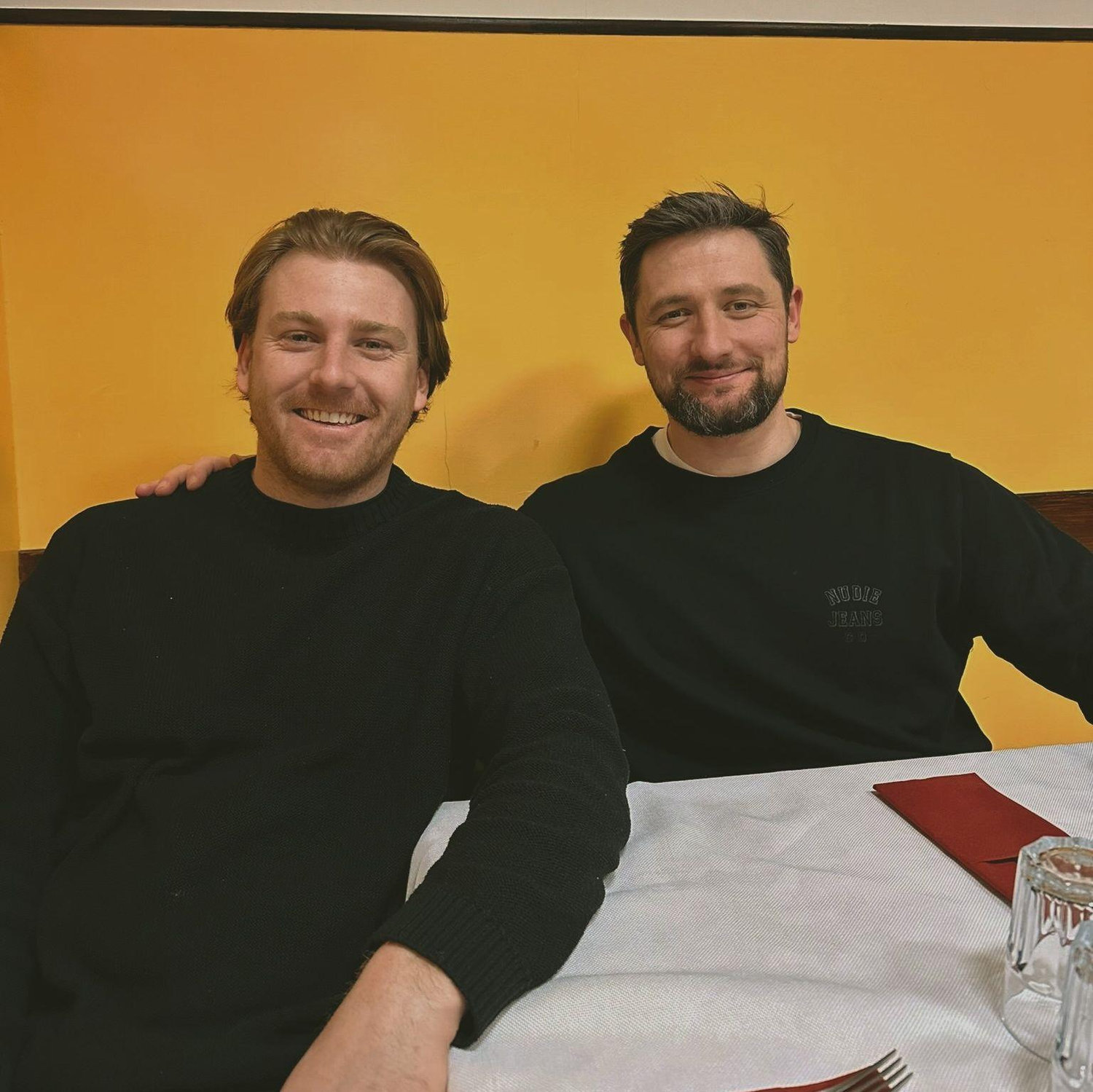 Jake & Nick in front of a yellow wall.