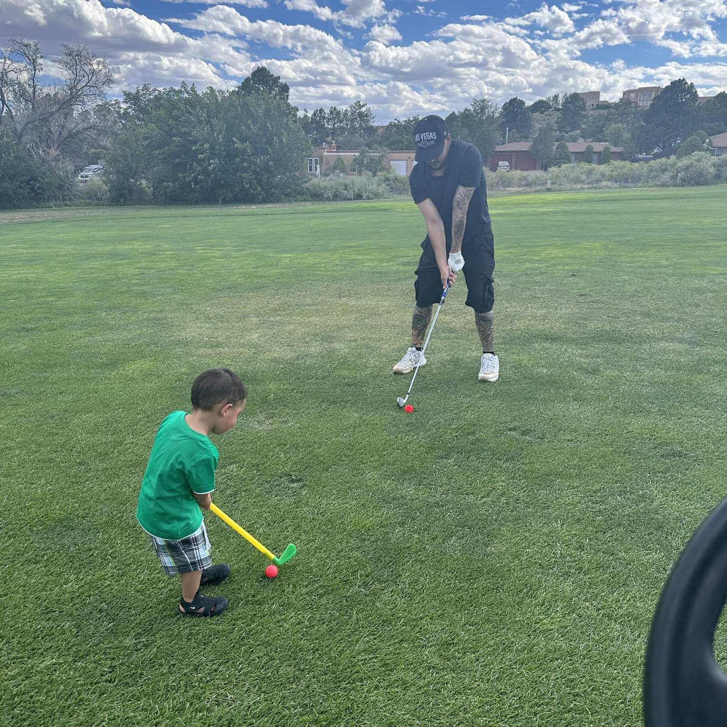 Learning to golf with Daddy Chris.