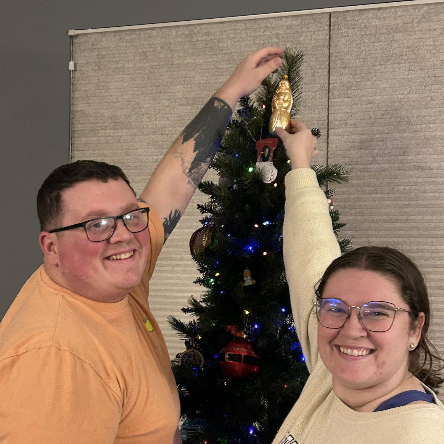 Putting the “topper” on our first Christmas tree! We didn’t have a real one lol (2024)