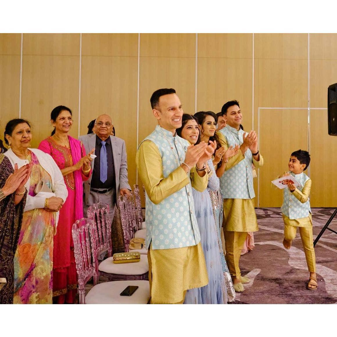 A variety of styles are pictured including a multi-colored indo-western full length dress, a pink women's Kurta and skirt set, and men's yellow Kurta with vest