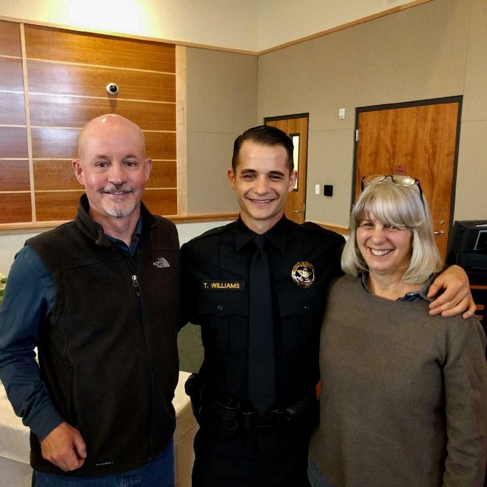 Tim and his parents celebrate Tim becoming a cop!