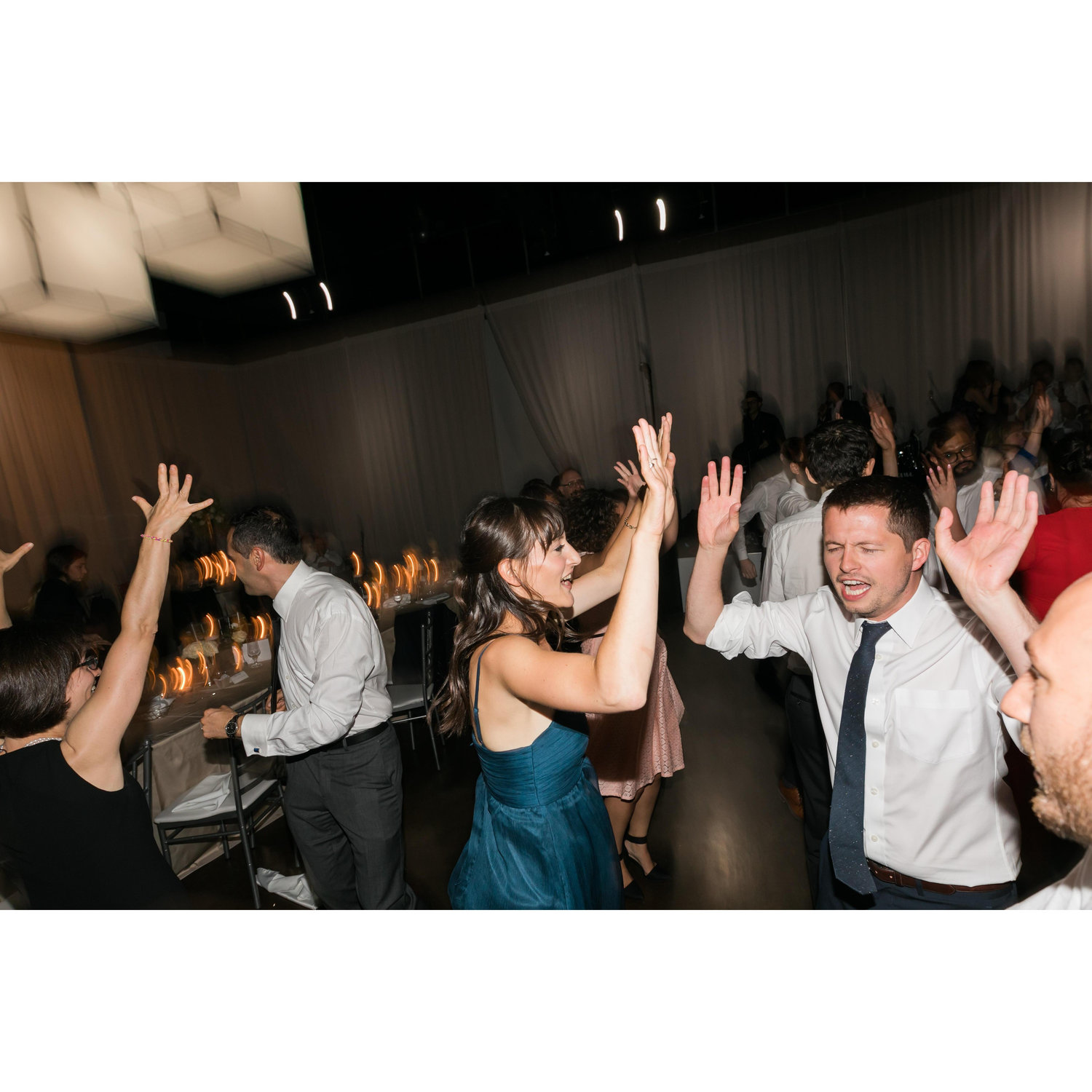Erin's wedding getting quite into, I want to say Shout by Otis Day and the Knights? That would explain the arm gesturing.