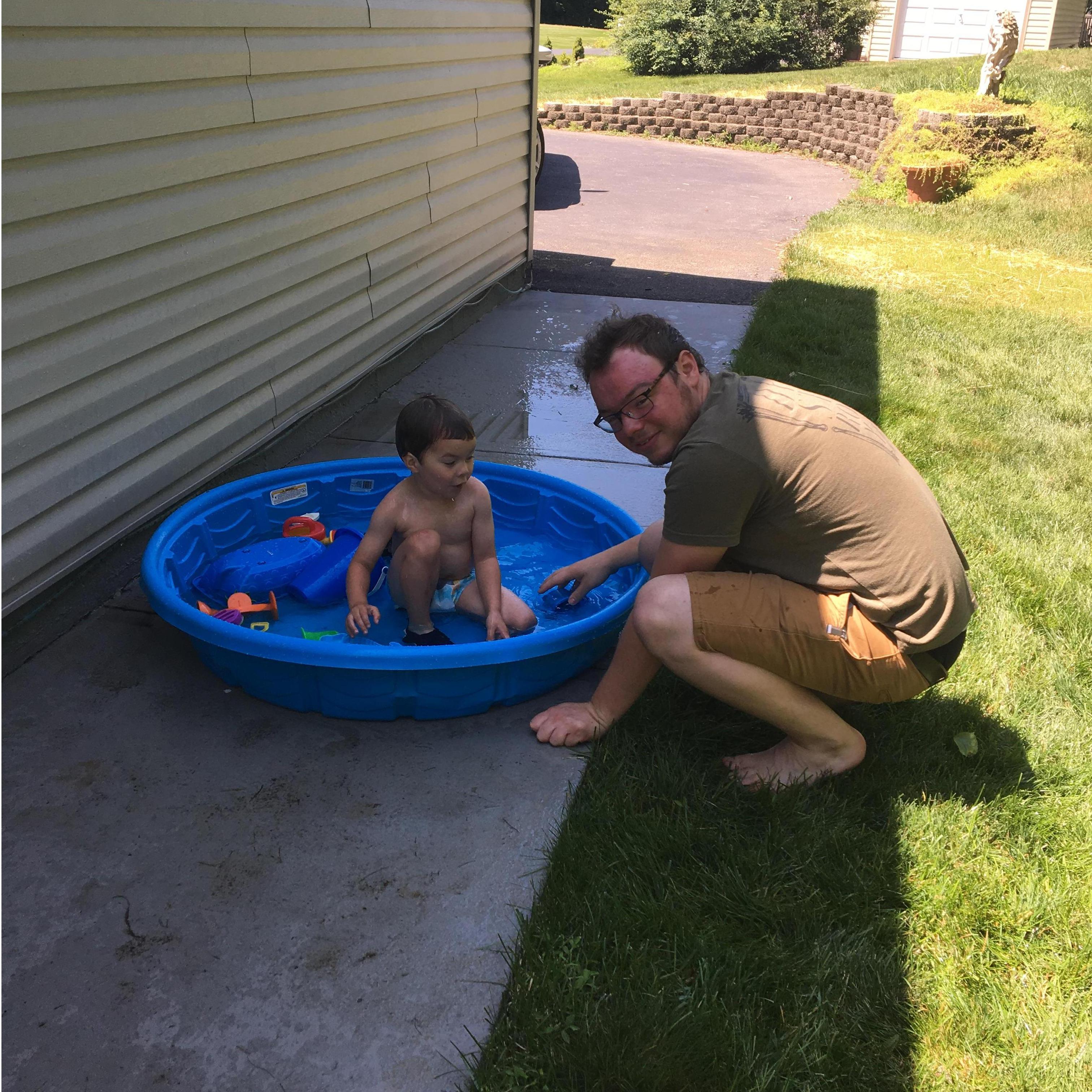 Nate playing with Gabe in the pool