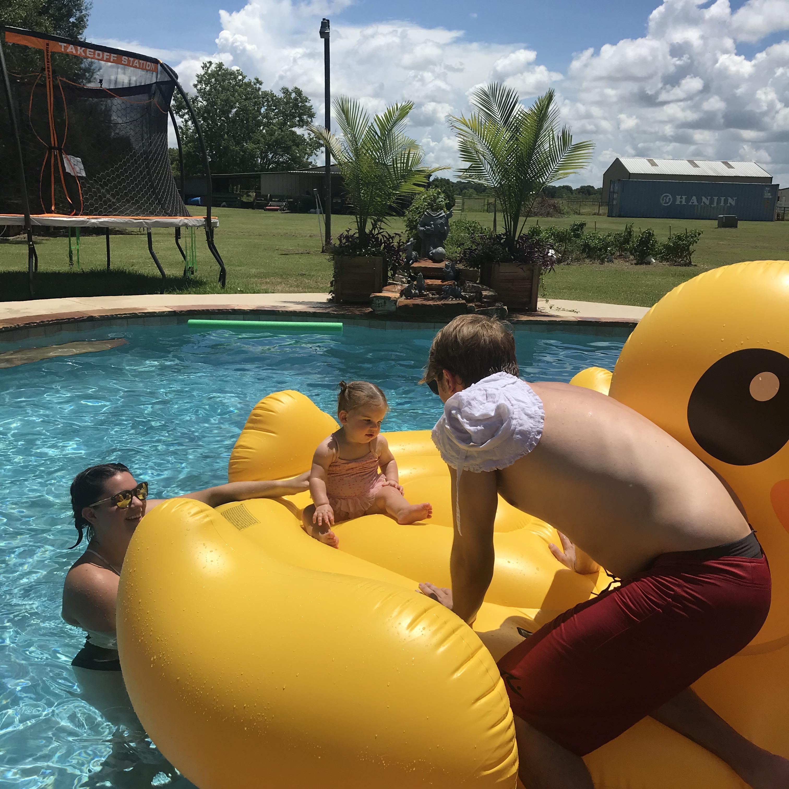 Trying to keep baby Emerson on the giant duck