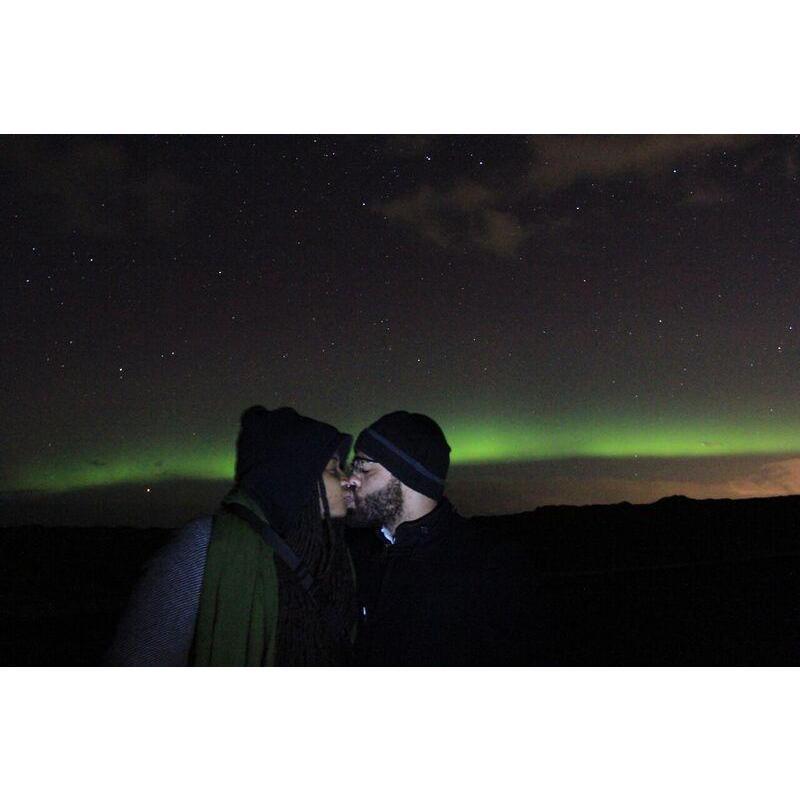 A kiss beneath the dancing Northern Lights in Iceland