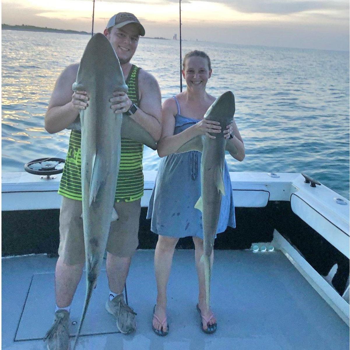 Brandon had to hold Sarah's shark because it was almost the size of her! Sarah caught the biggest and the smallest shark of the trip! We released the sharks after the pictures.