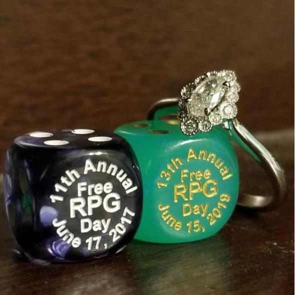 The dice on the left is from the event that Amber and Matt met at in 2017, the dice on the right is from that same event 2 years later when Matt proposed to Amber!