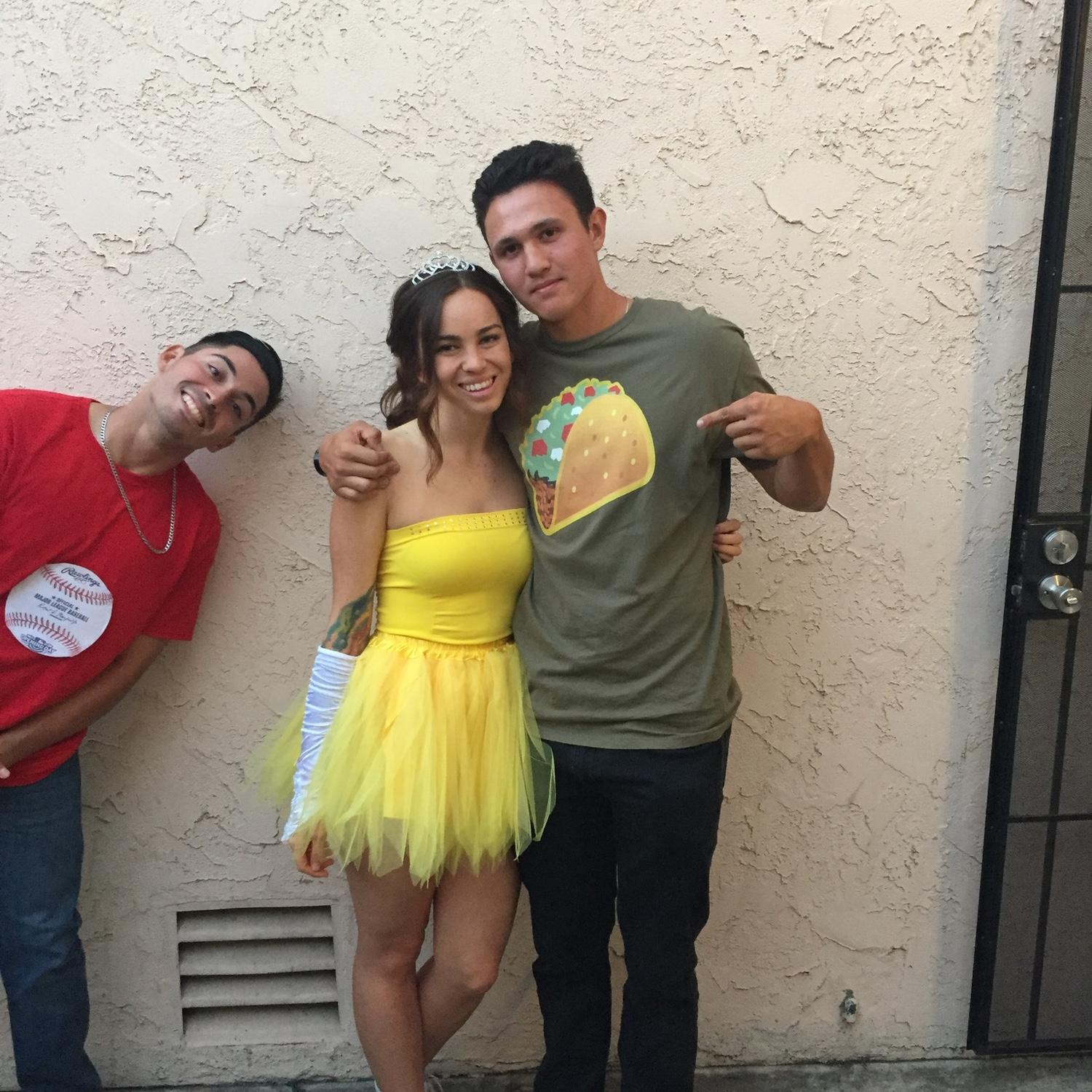 October 2017: Officially a couple! Kellie takes Alex to one of her riveting sorority formals (dressed as Taco Belle), and of course, Michael Palos had to make an appearance.