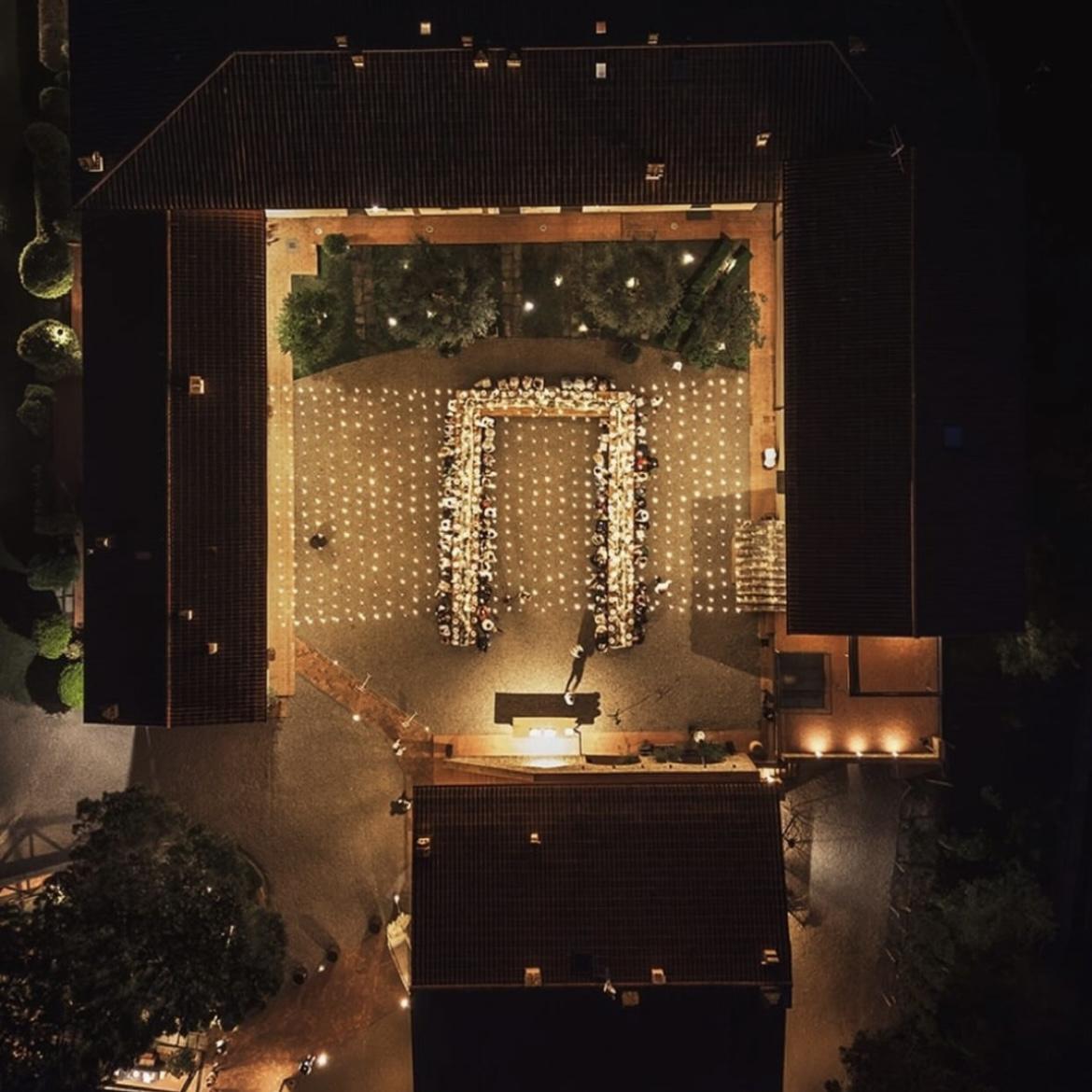 The villa’s courtyard glowing with string lights and surrounded by stone walls that have stood for centuries.