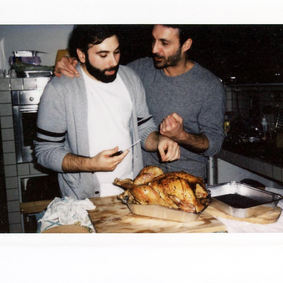 Ale being encouraged by his friend Dario as he carves his first turkey in Vigevano, 2017