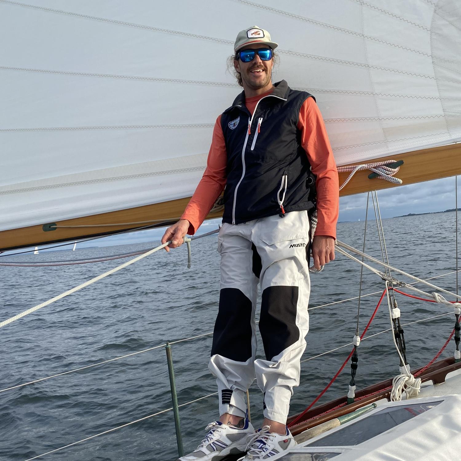 Tom teaching Lucy how to sail a NY32.
