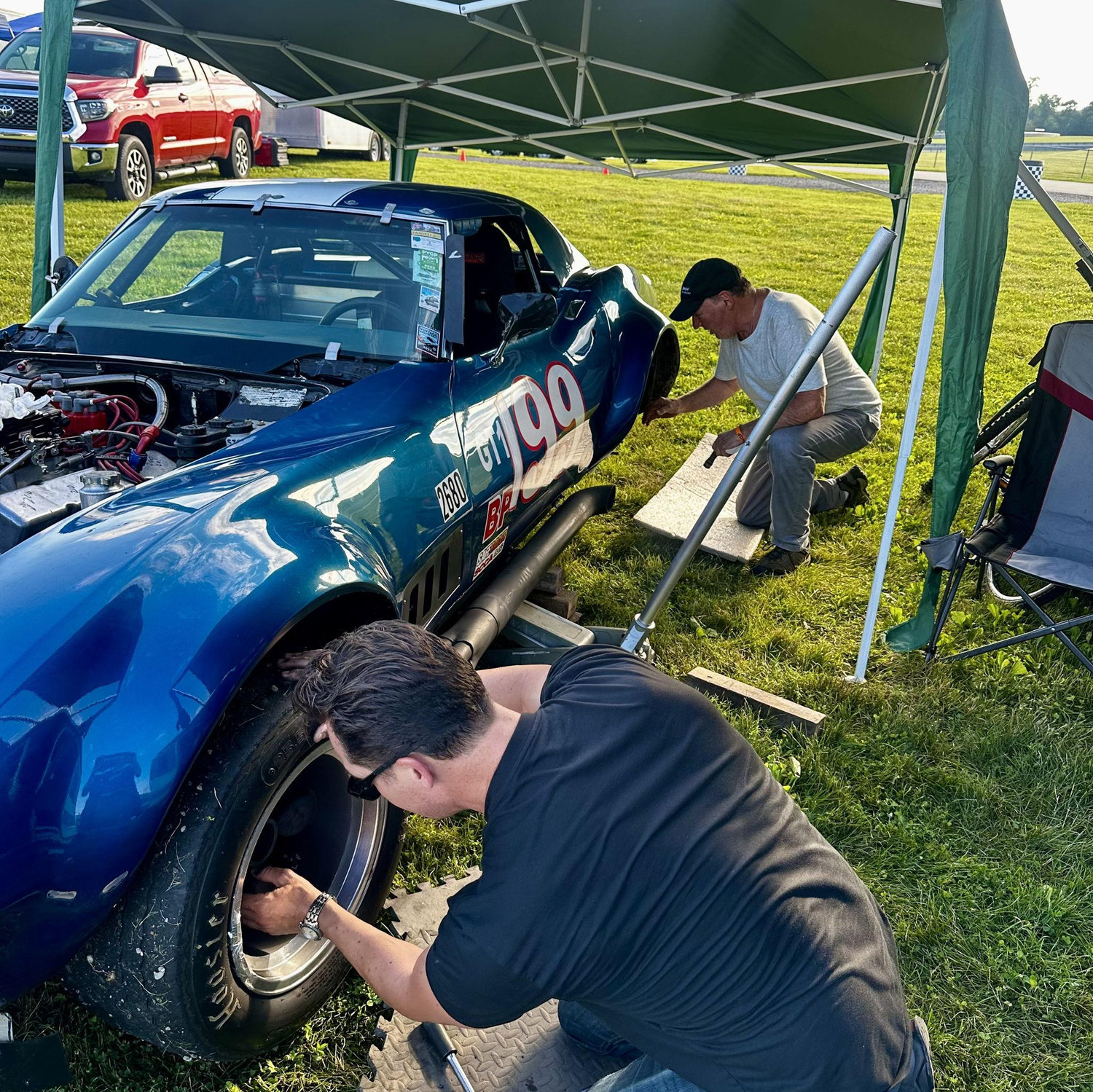Tim helping my Dad change out his racing slicks.