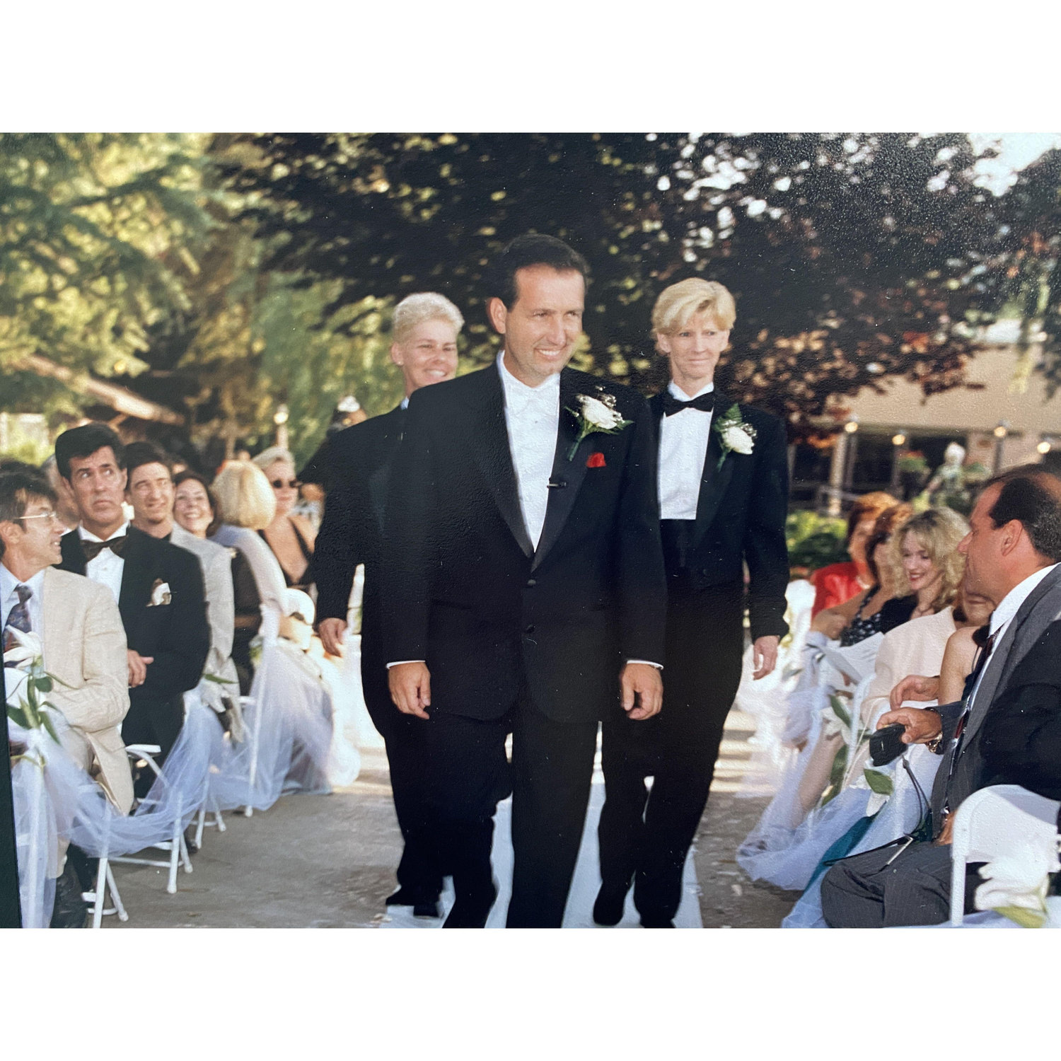Susie and Cheryl walking James down the isle.