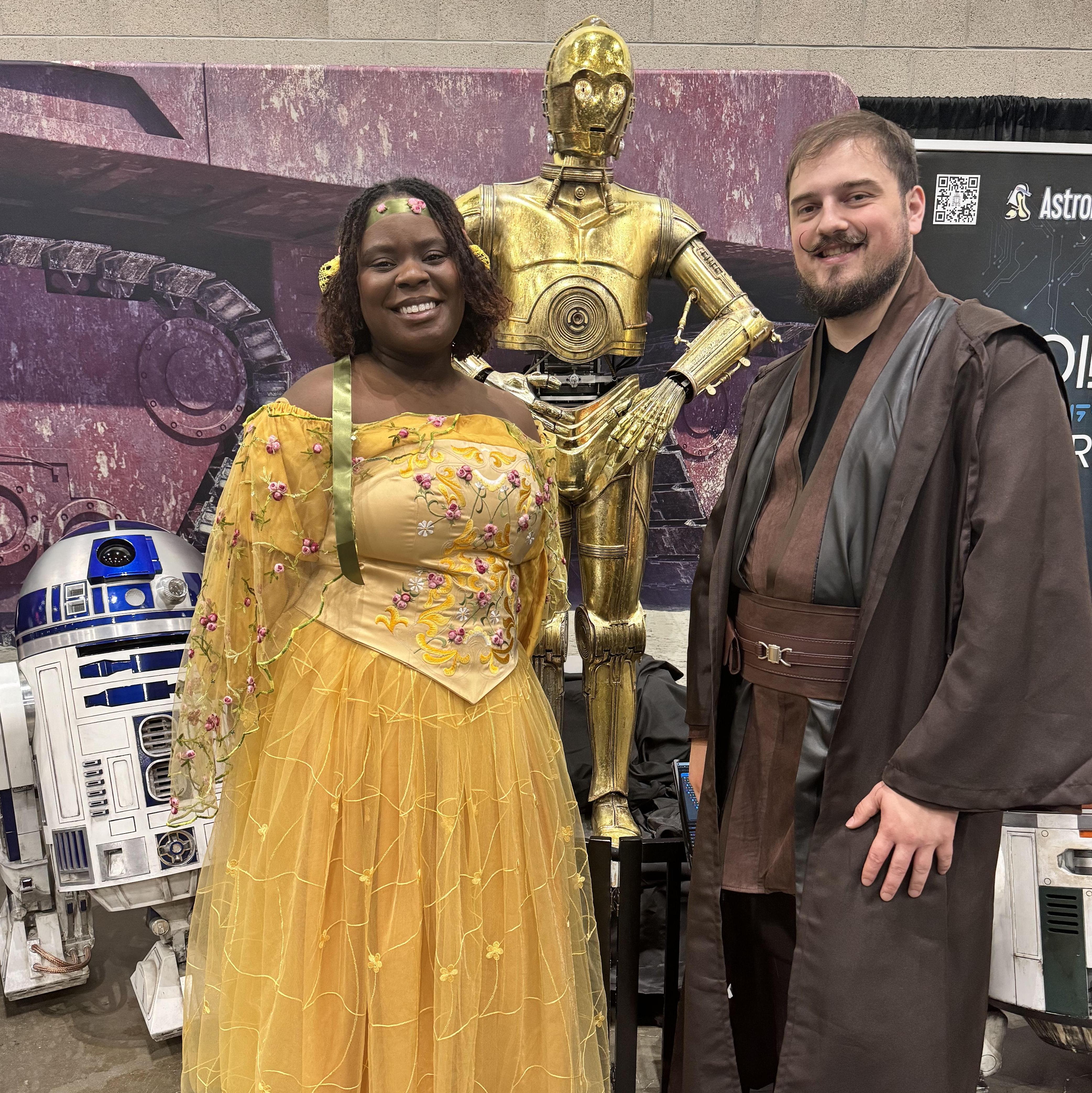 Cosplaying at LA Comic Con in their engagement outfits. Should they exchange droids instead of rings at the wedding?