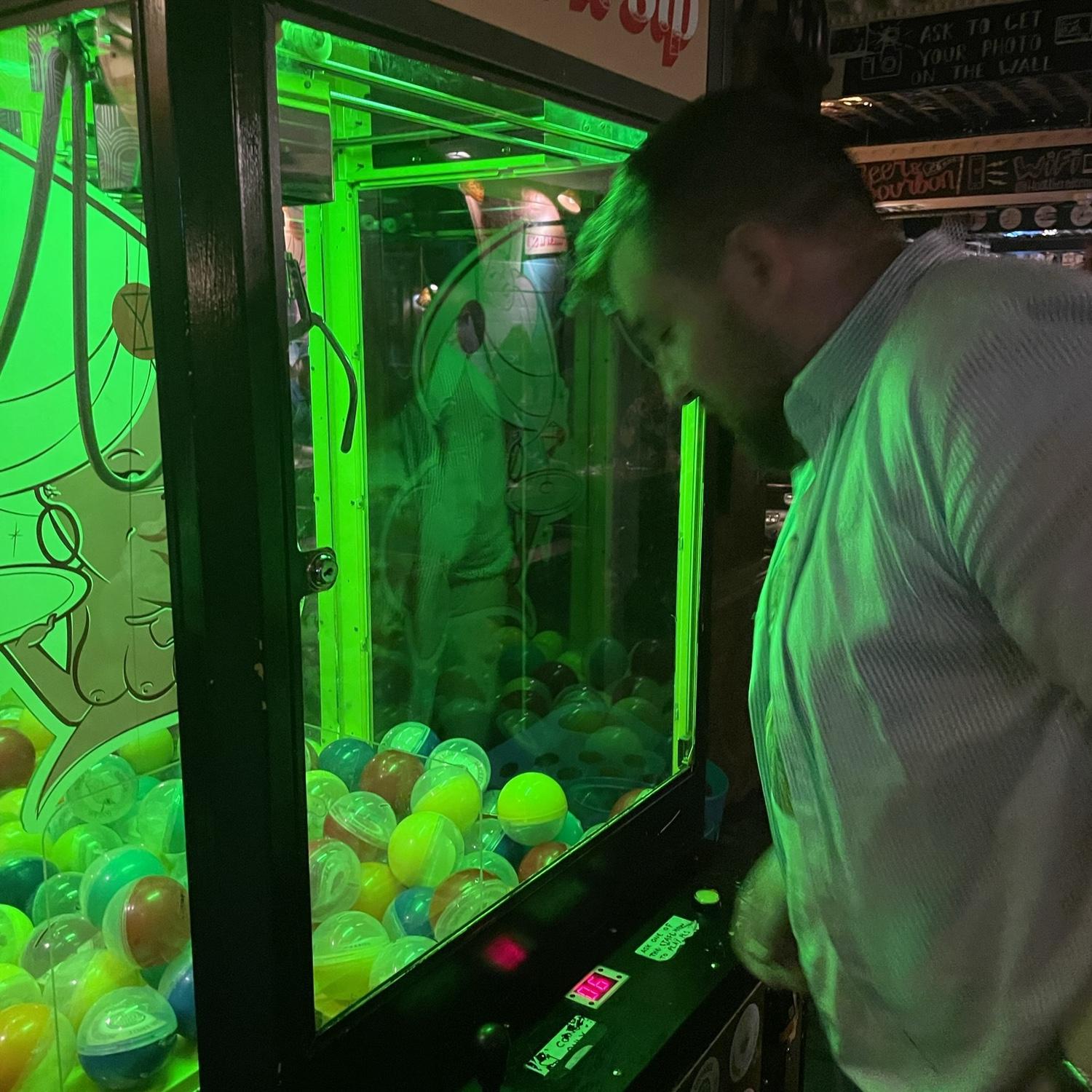 Picking flavors with the claw machine to build a cocktail.