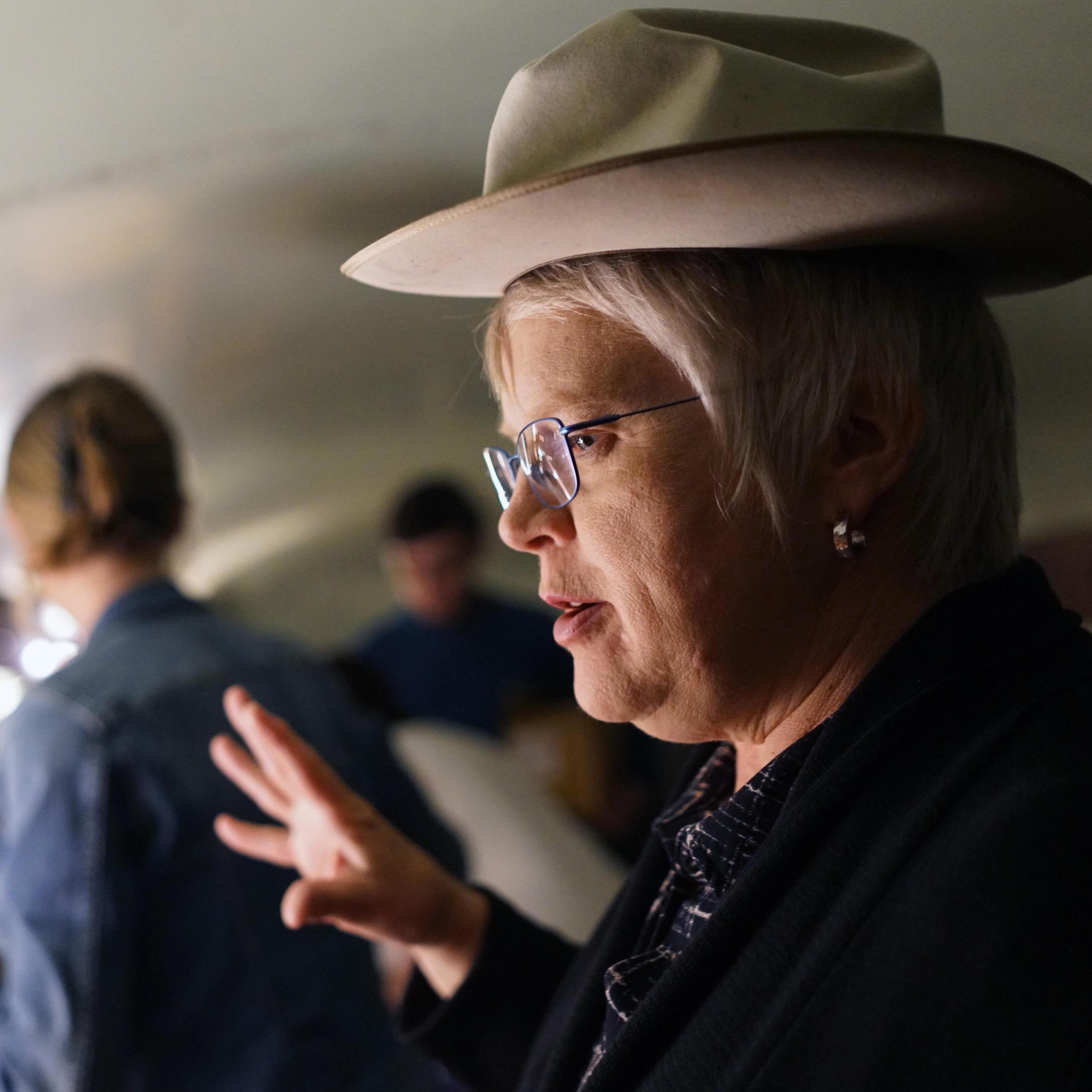 Sarah, explaining the finer points of selecting the proper hat size.