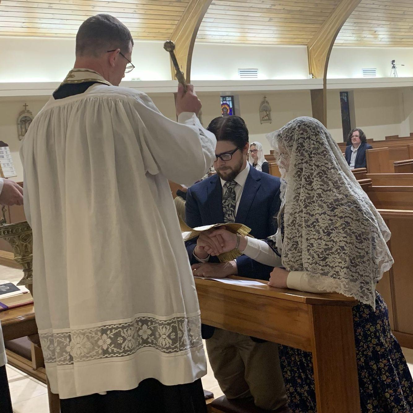 Their priest blesses their engagement/betrothal.