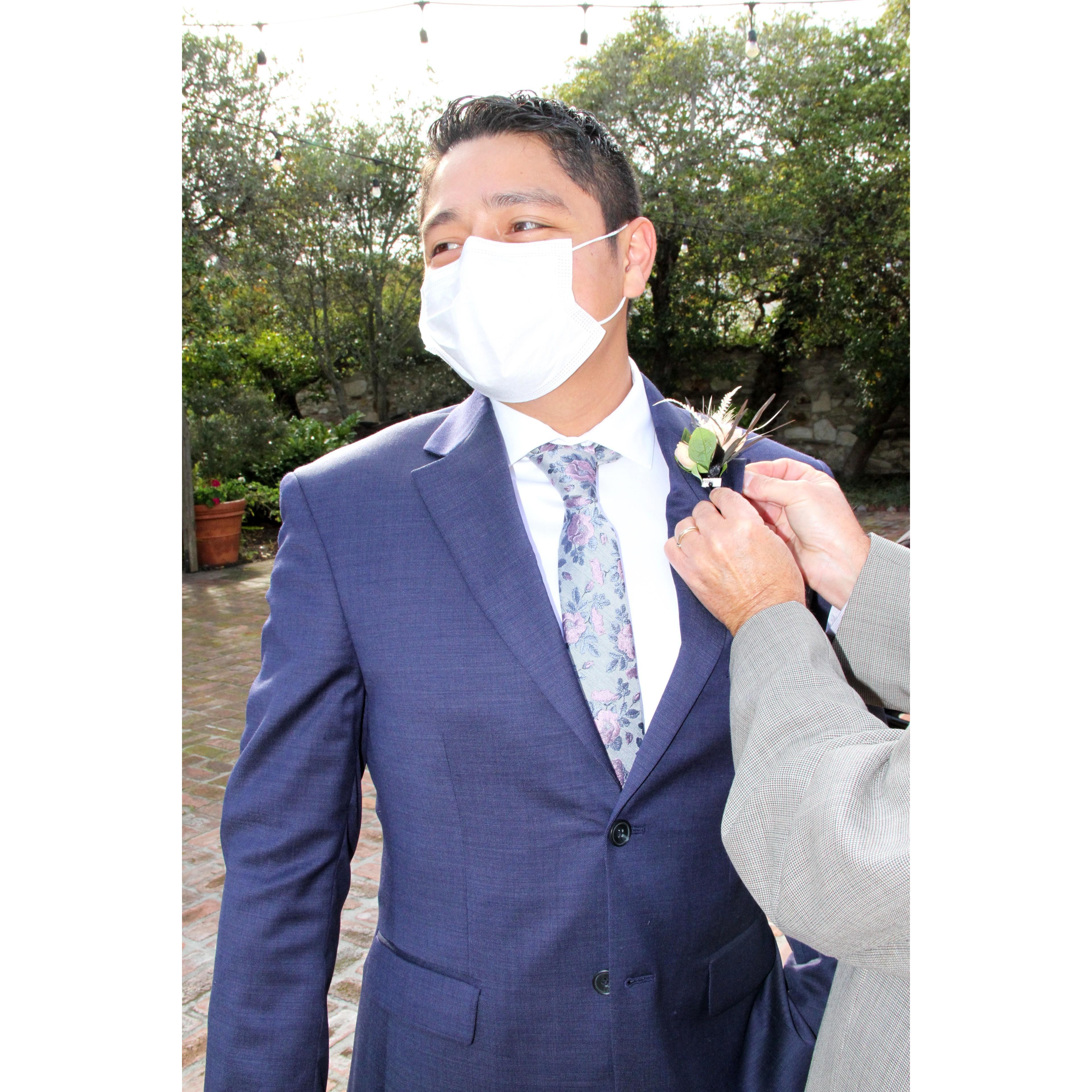 Groom's boutonniere pinned on by the Father of the Groom