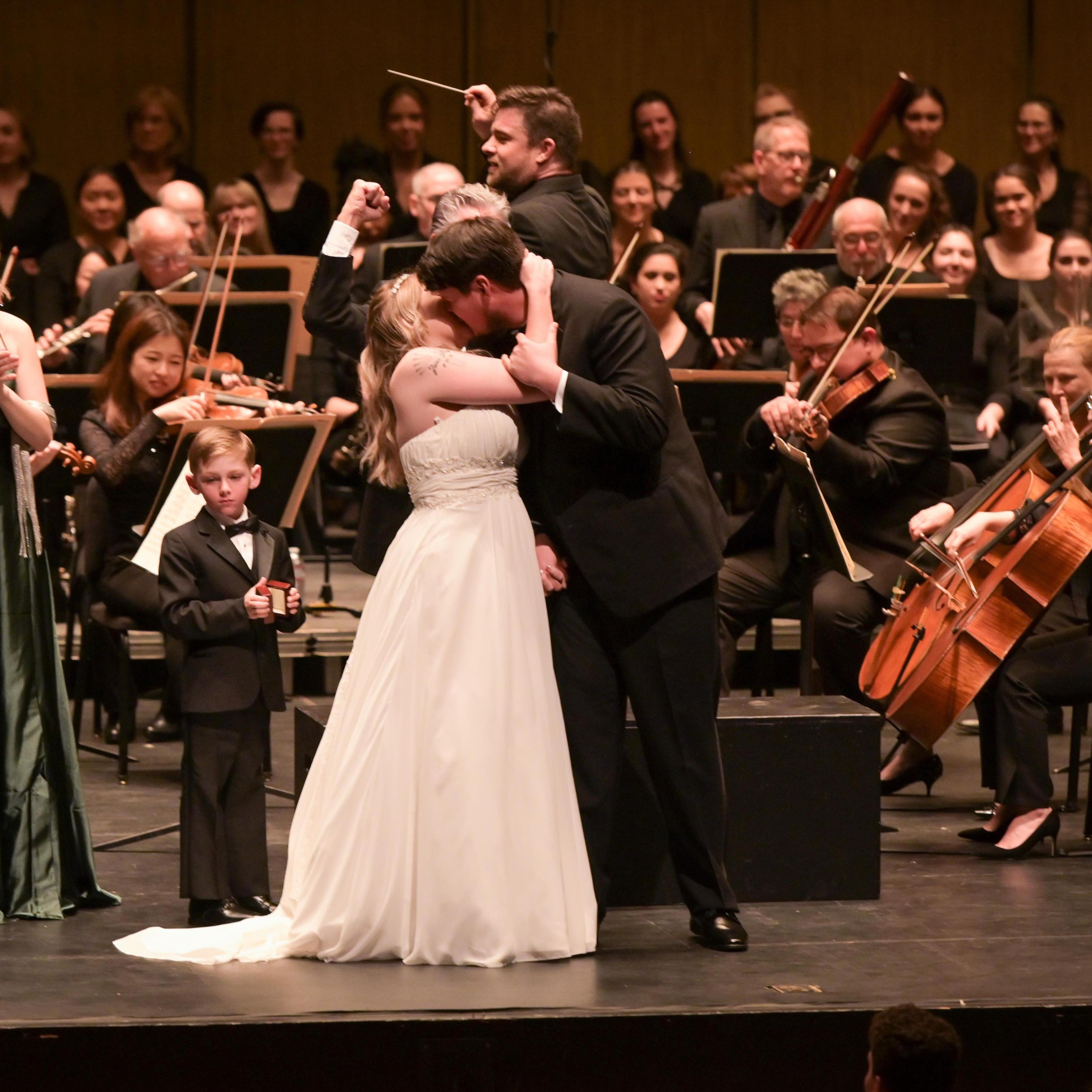 The first kiss as newlyweds, New West Symphony orchestra behind us, with Music Director Michael Christie waving in the first trumpet notes of Felix Mendelssohn's Wedding March.