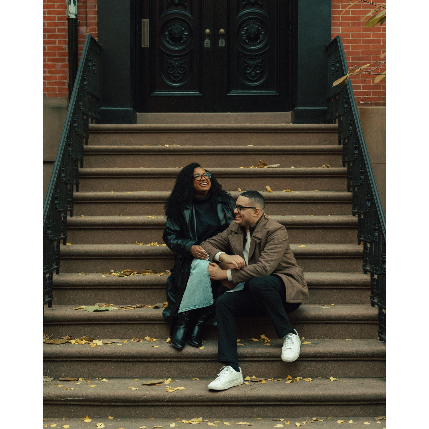 Sharing a laugh on the steps of a West Village brownstone—Déja and Kevin’s favorite hangout spot during their college days.