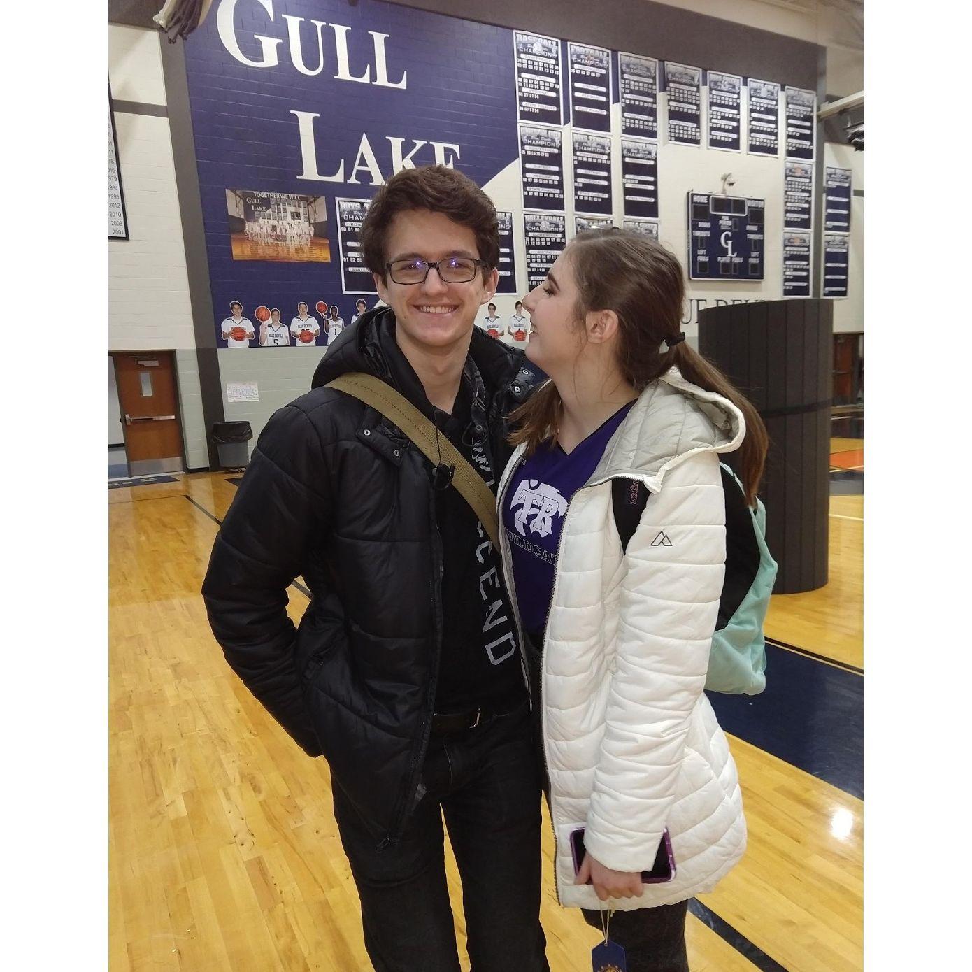 Ethan trying to be Allie's height at a cheer competition